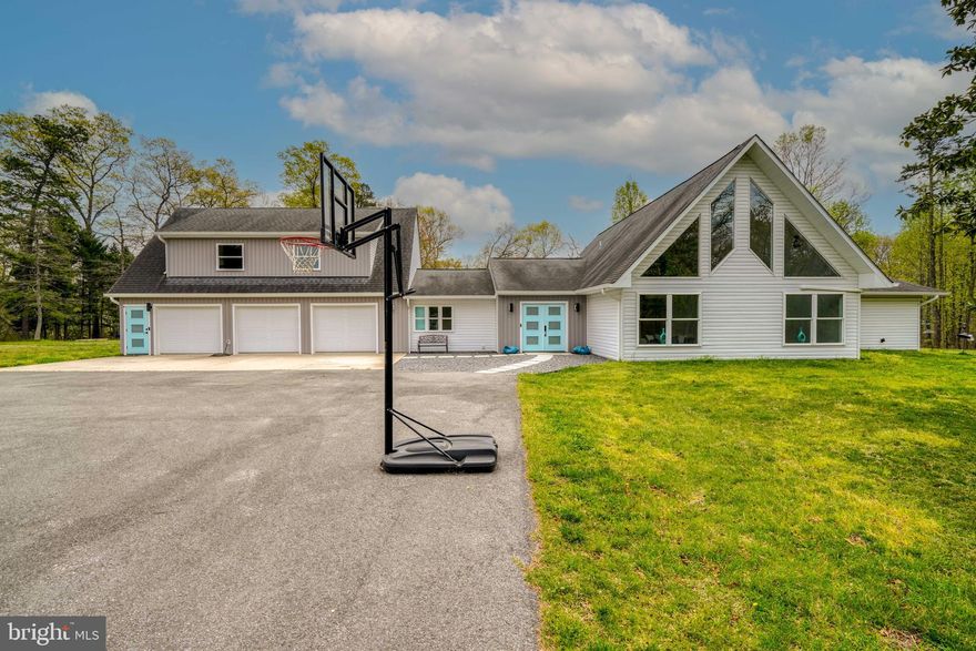 Welcome to your serene sanctuary at 1267 Sleepy Hollow Rd, nestled on 10.04 acres of picturesque landscape in beautiful Severn, MD. This expansive property offers the perfect blend of luxury, comfort, and versatility.  This exquisitely renovated 5-bedroom, 4.5-bathroom estate seamlessly blends modern luxury with rustic charm.   Step inside to discover elegant finishes, luxurious quartz countertops, wood mark cabinets, modern LVP floors, and abundant natural light throughout. The gourmet kitchen is truly a chef's dream offering top-of-the-line stainless steel appliances, and a built-in microwave that also operates as a convection oven, as well as an oversized kitchen island making it perfect for family gatherings. The primary suite offers its own private deck, a spa-like bathroom with a walk-in shower, his-and-her vanities, and 2 walk-in closets.   Car enthusiasts and hobbyists will love the 3-car garage/workshop providing plenty of room for vehicles, storage, and hobbies. The expansive grounds offer endless outdoor activities such as paintball, hunting, gardening, shooting, and fishing on the Severn Run River that runs through the property making it perfect for memorable family events right in your own back yard. Spend mornings on one of the three rear decks, sipping on your coffee while enjoying manicured landscaping and breathtaking views. The in-law suite located above the garage offers additional living space for extended family, guests, or potential rental income. This independent living space provides a bedroom, bathroom, living area, and private entrance, complete with an electronic chairlift for stair accessibility.   But that's not all...along with all of these amazing features you also have the ability to build another home of any size per the deed making the potential value of this home immense.   The homeowners are also offering to give the buyer a choice of a roof replacement or a 15k credit. The convenient location gives the perfect balance of privacy and accessibility, with easy access to nearby amenities, schools, shopping, dining, and major commuter routes. Don't miss your chance to own this exceptional property and experience the ultimate in luxury country living. Schedule you're showing today and start envisioning the endless possibilities.