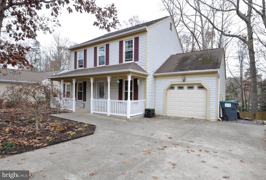 This charming colonial in the private community of Aquia Harbour in Stafford is ready and waiting on it s new owners. Light and warmth welcomes you from the moment you step into this all wood flooring home. The wood-burning brick fireplace is centrally located and sits between two floor-to-ceiling built-in, glass-front bookshelves. Large french doors lead you out onto a multi-tiered deck and look out over the fenced-in and wooded backyard. A dining area conveniently connects to the living and kitchen areas. The beautifully designed kitchen area with a uniquely custom breakfast hardwood bar is just off the open living and dining areas. A door separating the kitchen from the laundry room and mudroom allows for convenience and ease and provides access to the garage. The beautiful hardwood stairs leading to the upper level, offers two nicely sized bedrooms and a full bath as well as a master bedroom with a chic and modern private bath. The shower was specially designed with multi-shower heads and a polished stone base and enclosed with glass doors. Back on the main level, steps from the kitchen take you down to the open finished basement living area with additional office space and storage room. The outside entrance leads to another decking area. There are so many lovely  touches added to this charming home it should not be missed. Aquia Harbour offers its residents a golf course, country club and restaurant, stables, pools, a marina, parks and a 24-hour security gate plus certified police department. Close to I-95, commuter lots, and the VRE, it s a convenient location for those travelling north for work. Quantico is only 8 miles from the main gate and 25 miles from Ft. Belvoir. Old Town Fredericksburg is a 30 minute drive. Shopping is also close by. A ONE YEAR AMERICAN HOME SHIELD WARRANTY IS PROVIDED.
