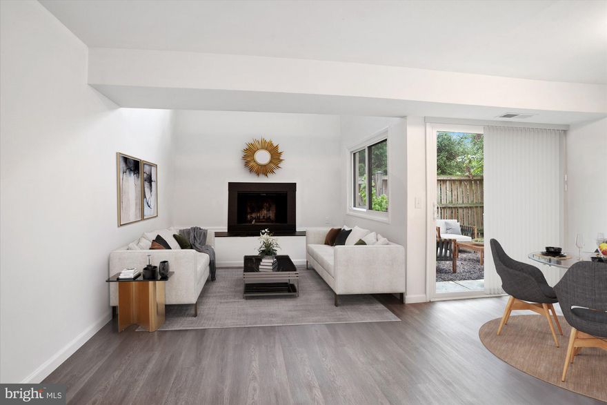 Sleek and Stylish Condo in the heart of it all in sought after Columbia! Stunning renovations complete this bi-level modern floor plan with soaring vaulted ceilings that give a sense of grandeur in the living room. The home has a sophisticated color palette finished in hues of grey, white, and black.  Modern lighting and accents adorn the home and the finishes will satisfy discerning buyers. Luxury Vinyl Plank flooring completes the first floor and new carpet spans the stairwell and bedrooms on the upper level. The Kitchen was finished with  Frigidaire Stainless Steel Appliances, granite countertops, and new White Cabinetry.  This spacious condo has over 1,200 sq ft of living space, including 3 Bedrooms, 2 Baths, a formal dining room, and spacious living room.  The Master Bedroom is on the main level and is separate from the primary living spaces. It boasts a fully renovated en-suite bathroom, large walk-in closet, and vaulted ceiling. The living room is open, airy, and bright with a rarely found wood burning fireplace! Just imagine relaxing by a crackling fire on cold winter nights!  New  energy efficient windows were installed throughout the home along with 2 new sliding glass doors that open to an outdoor patio, which is perfect for a table, chairs, and BBQ grill.  This outdoor space is a great amenity for condo living. The upper level has 2 generous sized bedrooms and a full bath- also renovated with ceramic tile, new cabinetry, and quartz counters. The home is so conveniently located across from Howard County General Hospital and Howard Community College. Swansfield CPRA pool is down the street and the home is approximately a mile to Columbia Mall, Lake Kittamaqundi, and Merriweather Post Pavilion!  Quintessential Columbia living!