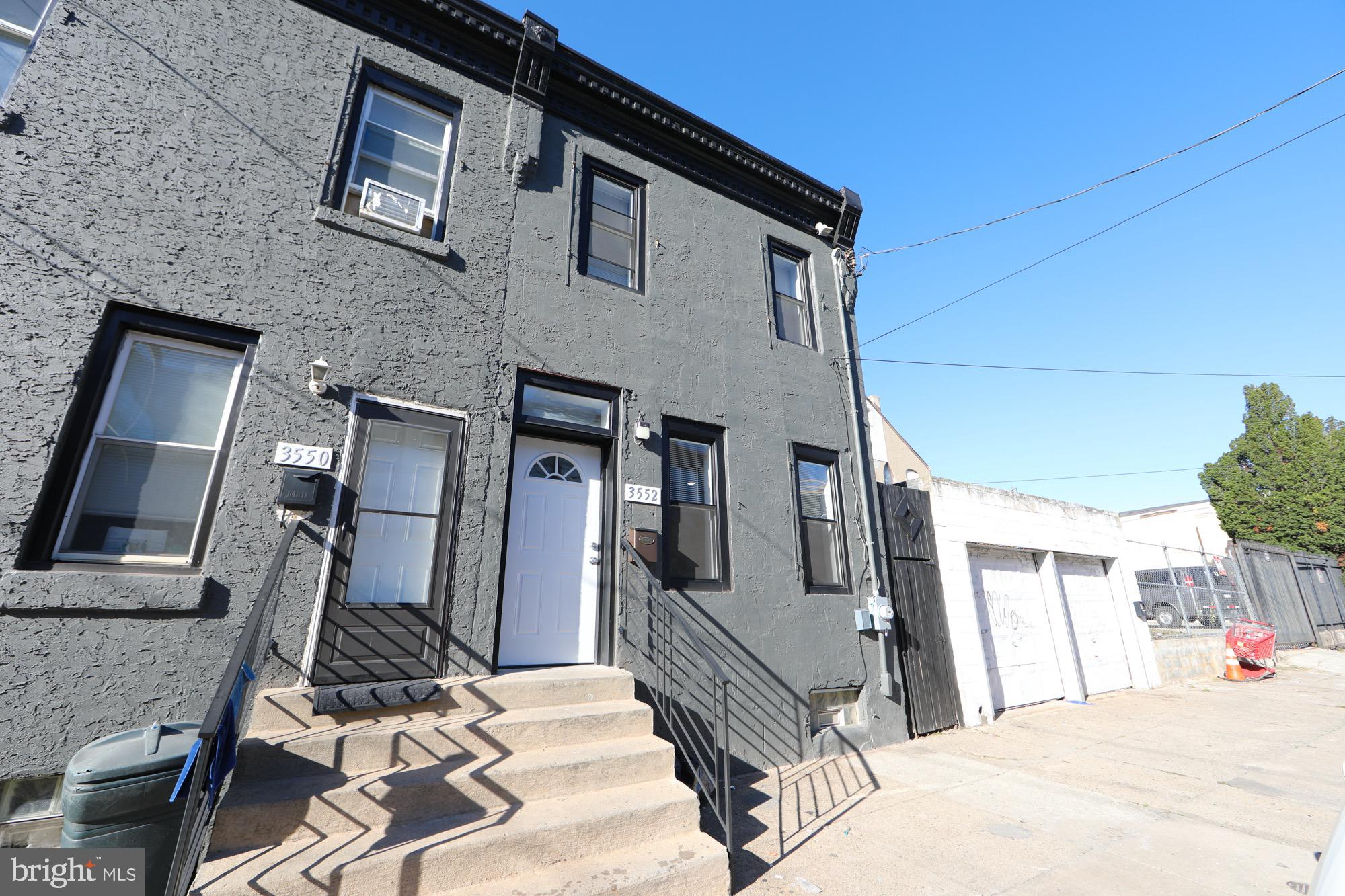Welcome to this beautifully renovated end-unit townhouse in the heart of Harrowgate Heights, Philadelphia! This 3-bedroom, 1.5-bath home has been completely redone from top to bottom and offers a perfect blend of modern upgrades and timeless style. Upon entry, you're welcomed by an open floor plan filled with natural light, featuring recessed lighting, rich wood floors, and brand-new windows throughout. The spacious living and dining areas flow seamlessly into the stunning kitchen, which boasts sleek white cabinetry, ample storage, and stainless steel appliances including a built-in microwave, dishwasher, and refrigerator—all accented by stylish, modern fixtures. Upstairs, you’ll find three generously sized bedrooms, each with ample closet space. The full bathroom is a standout, featuring crisp white tile, a modern vanity, and a glass-enclosed stall shower that adds a spa-like touch. The unfinished basement offers excellent potential, ideal for storage, a home gym, office, or entertainment space tailored to your needs. Enjoy the perks of being an end unit with a spacious backyard, perfect for entertaining, gardening, or summer barbecues. With central air and a new HVAC system, comfort is built in year-round. This is a fantastic opportunity to own a truly move-in ready home in the up-and-coming Harrowgate Heights neighborhood. Enjoy nearby local favorites like PrimoHoagies, La Cocina del Don, and convenient access to shopping and public transportation. Don’t miss your chance to be part of this vibrant and growing community, schedule your showing today!