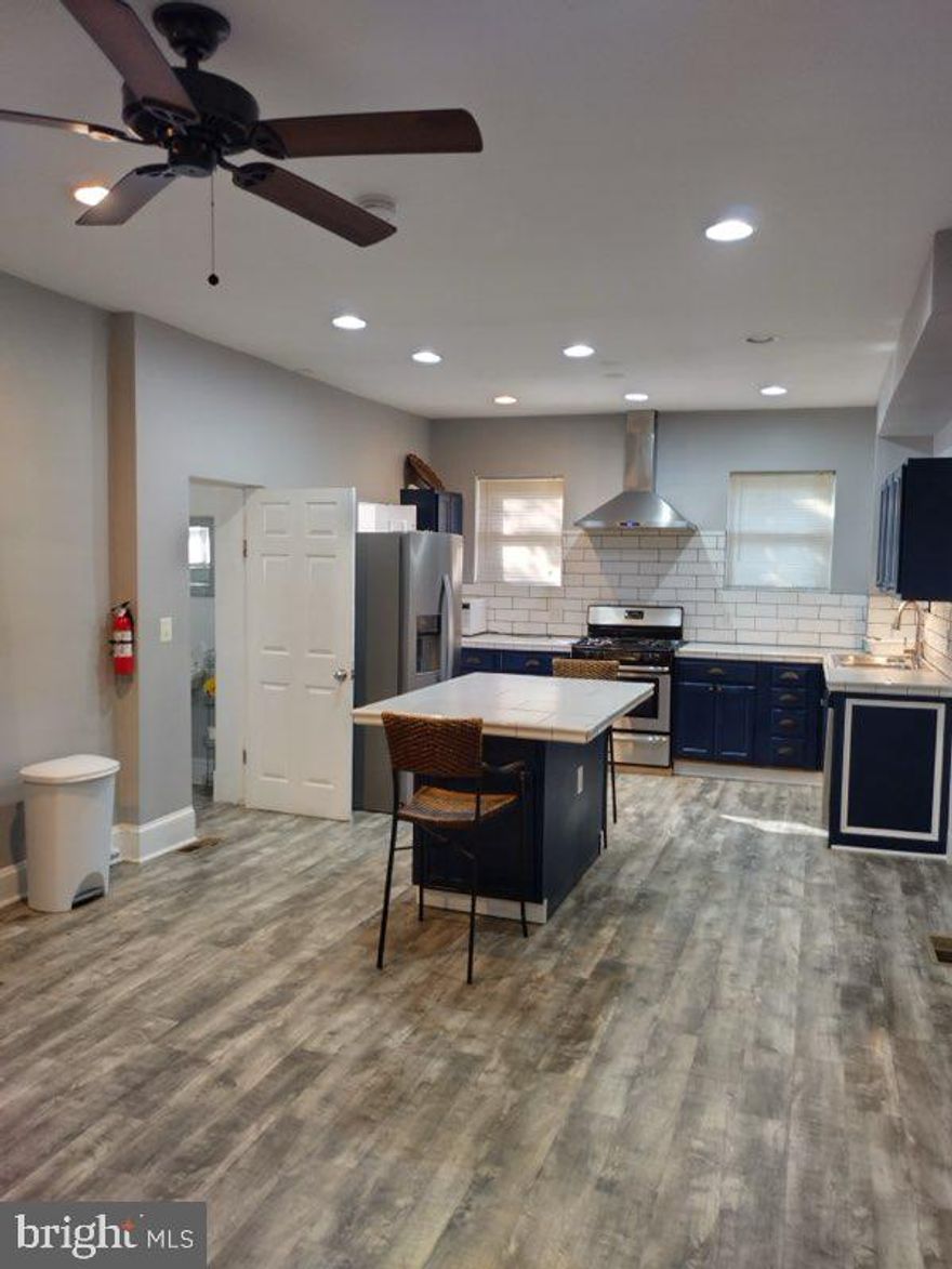 Welcome to this spacious 4-bedroom, 2.5-bath Cape Cod featuring modern updates throughout. The home offers laminate wood-look flooring, a bright and stylish kitchen with tile countertops, and beautifully updated baths. Enjoy gatherings in the open living and dining spaces or step through patio doors to a large backyard with a private patio area, perfect for entertaining. A covered front porch adds classic charm, while the unfinished basement provides excellent storage or future living space potential.