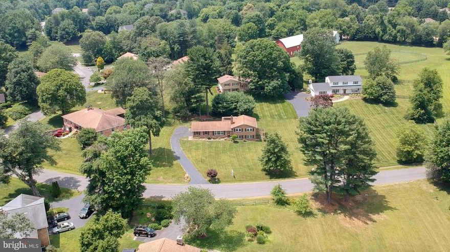 MOTIVATED SELLER – Opportunity Knocks!   Welcome to 2736 Calkins Rd in Moneys Corner—a rare equestrian community in the Crossfield ES, Carson MS, and Oakton HS pyramid. This beautifully landscaped half-acre lot offers stunning lake views with close proximity to the community-owned barn and pasture.  **PLEASE NOTE that the square footage listed in public records is inaccurate. The home includes three above-grade levels, totaling approximately 2,287 sqft, plus an additional finished, large below-grade area. Buyer is responsible for verifying all measurements.**  Renovated in 2019, this 4-level home features a modern open floor plan with hardwood flooring, a spacious living room with picture window (frameless TV conveys), dining area, and a gourmet kitchen with center island, quartz countertops, with custom backsplash, and stainless-steel appliances/gas cooking. Entry from the side-load garage leads directly into the main level, which also includes a full bath and a three-season room off the dining room for year-round entertaining.  Upstairs you'll find hardwood floors, a laundry closet with stackable washer and dryer and storage shelving, two generously sized bedrooms and two full baths. The primary suite has a walk-in closet and a stall shower.  The walk-out lower level features LVP flooring, a family room with a wood-burning fireplace, and windows looking out to the lake, as well as a large bedroom en-suite.  The second lower level (below grade) offers a rec room and a bonus room ideal for storage or crafts and a workshop.  The rear yard is fenced with a new patio and walkway around to the garage and a shed.  Moneys Corner amenities include a 14-stall barn with electricity, water, tack house, fenced riding ring, and pastures ($50/month stall fee). Residents enjoy 21 acres of common ground, a stocked lake, gazebo, and fishing dock. Low HOA dues of $550/year. Prime location near major commuter routes, Metro stations, shopping, and dining. Plus, walk to the Reston South Park & Ride and Fox Mill Shopping Center. Recent Updates Include:  (2025) Concrete Patio and Walkway (2023) AC Unit, Porch Roof Replaced and Screened-in-Porch Converted to a 3-Season Room with Operable Windows (2020) Windows Replaced on Main Level and Recreation Room  (2019) Walls Opened Up /Flooring Throughout/Kitchen Cabinetry, Countertops, Stainless Appliances/Fixtures/ Reconfigure Bedroom Level and Added a Full Bath and Laundry/Added a Full Bath on Main Level/ Stormwater Management System/Septic Distribution Box Replaced and Inspected, Perks for 4 bedrooms. (2012) Roof/Hot Water Heater/Windows in Bedrooms, Bathroom, Kitchen, and French Doors/HVAC System Seller to provide a 1-year Cinch Home Warranty.