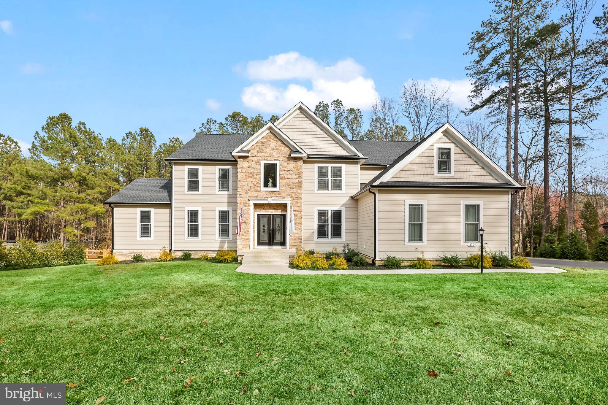 Welcome home to this two year old, custom-built home by JOHN ROBB Custom Homes in the desirable Fawn Lake Community. Luxury meets comfort in this 4200+ finished square feet home plus an additional 2200+ unfinished square feet in the basement. Stunning architecture and no details were overlooked in the craftsmanship of this home. Boasting elegant trim work and rounded corners throughout this inviting and extraordinary home. Situated perfectly on 1.44 acres, you are surrounded by mature landscaping with winter views of the lake and golf course. You are first greeted by the two story foyer, elegant LVP flooring, and tons of natural light. Entertain and relax in the front sitting room and dining room where there is plenty of room for family and friends. The two story family room draws you in with it's coffered ceiling with modern light fixture, floor to ceiling stone fireplace, and magnificent views of the tree lined backyard. The chef-inspired kitchen features quartz countertops, upgraded cabinetry with soft close drawers and lighting underneath the cabinets, dual wall ovens, six burner gas cooktop with griddle and a wall mounted pot filler above it, side by side column refrigerator and freezer, farmhouse sink, built-in wine fridge, an island that seats four comfortably, walk-in pantry with pocket doors, and kitchen table space with continued views of the backyard and access to the deck for grilling and entertaining. One of the homeowner's favorite areas is the new enclosed sunroom with a mini-split and two flush mount ceiling fans that allow you to enjoy this room year round. Walkout on the 30 foot long deck from here to continue the peacefulness of the area. There are two bedrooms on the main level that are connected by a full bathroom. This makes for a great guest suite or for anyone who doesn't want to use the stairs. A laundry room with a dog shower area and half bathroom complete the main level. Make your way to the upper level where there are four generous-sized bedrooms including the magnificent primary bedroom suite. This is your personal retreat with a spacious sitting area, an envious size walk-in closet and another closet perfect for shoes! This primary bathroom is your spa-like experience. The frameless, walk-in shower has dual shower heads, the garden tub sits perfectly with a picture window allowing in the natural light. One of the other bedrooms has its own ensuite bathroom and views of the backyard. The other two bedrooms are connected by a Jack and Jill bathroom. Looking for more room to expand? The unfinished basement is ready for you to finish the way you like - an egress window for a future bedroom, roughed-in for a future full bathroom, wet bar or kitchenette, and another laundry hookup. Currently, it makes for a convenient gym. Walkout on the patio for more areas to relax. This opens up to the fenced-in backyard that has two double gates on either side of the house and a single gate at the rear, which provides access to the creek and the remaining portion of the property on the other side of the creek. The backyard has tons of room for backyard activities including a future pool. The property goes past the rear fence and includes a resource protection area. Three car garage with huge driveway. NEW improvements include the enclosed sunroom, whole house generator, solar panels, and rear fencing. There are even outlets in the soffits so you can hang your holiday lights! Irrigation system keeps your yard looking beautiful! The builder's structural warranty is transferable to the new owner. Fawn Lake is rich in it's amenities including the lake and marina, Arnold Palmers' designed golf course, clubhouse with pool, fitness center, and so much more. Welcome to Fawn Lake living!