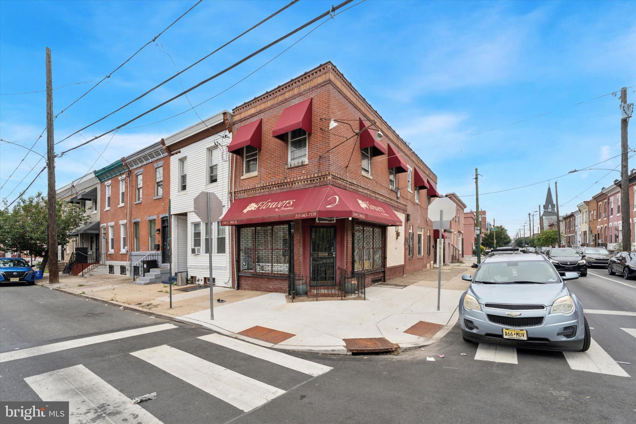 This amazing prime location mixed use corner is the one you have been waiting for! Previously a Flower shop, 1st floor Commercial features beautiful tin ceiling! also has 1/2 bath with large basement access, multiple rooms & 2 large Refrigerators. Possibly with this size can get permit/zoning for 3 units?! Note, per deed back rear room was previously a garage and possibly could be converted/ permitted back to garage. 2nd floor is a very large 2 bedroom apartment with a deck. Large open L/R - Kitchen concept and a nice size full bath. 2 bedrooms are freshly painted with lots of natural sunlight. *Property being sold AS/IS. Inspections welcome but only for Buyers due diligence.