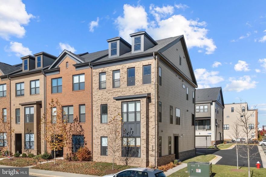 Stunning 4-bedroom end-unit townhouse just steps from Brambleton Town Center! The entry level offers a private bedroom with an adjacent full bath—ideal for guests or a home office. Flooded with natural light, the main level features an open-concept layout and a chef’s kitchen equipped with gas cooking, a massive center island, pantry, and recessed lighting throughout. Upstairs, you’ll find three well-appointed bedrooms, including a spacious primary suite with dual closets and a luxurious bath showcasing a dual-sink vanity and an expansive walk-in shower. The top level offers a versatile loft space—perfect for an office, playroom, or media area. Enjoy unbeatable location, features, and Brambleton HOA amenities! Close to Brambleton Town Center, highly rated schools, neighborhood trails, and Hal & Berni Hanson Park. HOA fees include trash/recycling, cable/internet, lawn maintenance, access to five community pools, and year-round events. This bright and beautifully designed home checks all the boxes!