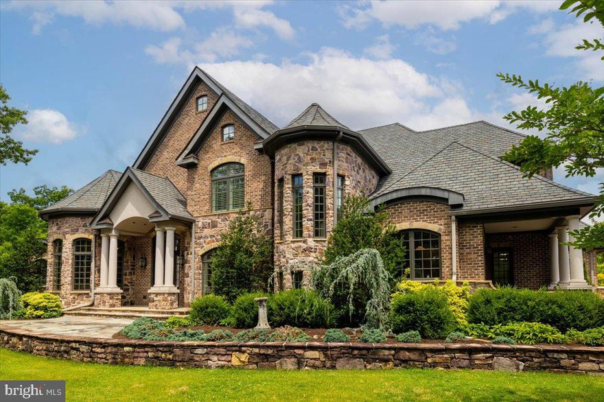 Perched atop Brush Mountain on 20+ private acres, this exceptional French Country manor offers sweeping views of Blacksburg just minutes from Virginia Tech. Thoughtfully designed with refined craftsmanship throughout, the home blends elegance and functionality. The gourmet kitchen and formal living areas provide an ideal setting for entertaining, while a well-appointed private office supports everyday business needs. The expansive primary suite features dual fireplaces, a sitting area, generous closet space, and a spa-like bath with air tub and radiant heated floors. Climate-controlled garages, complete with workshop, storage, and dedicated office space, make this property a rare opportunity—perfect for the discerning buyer or automotive enthusiast.