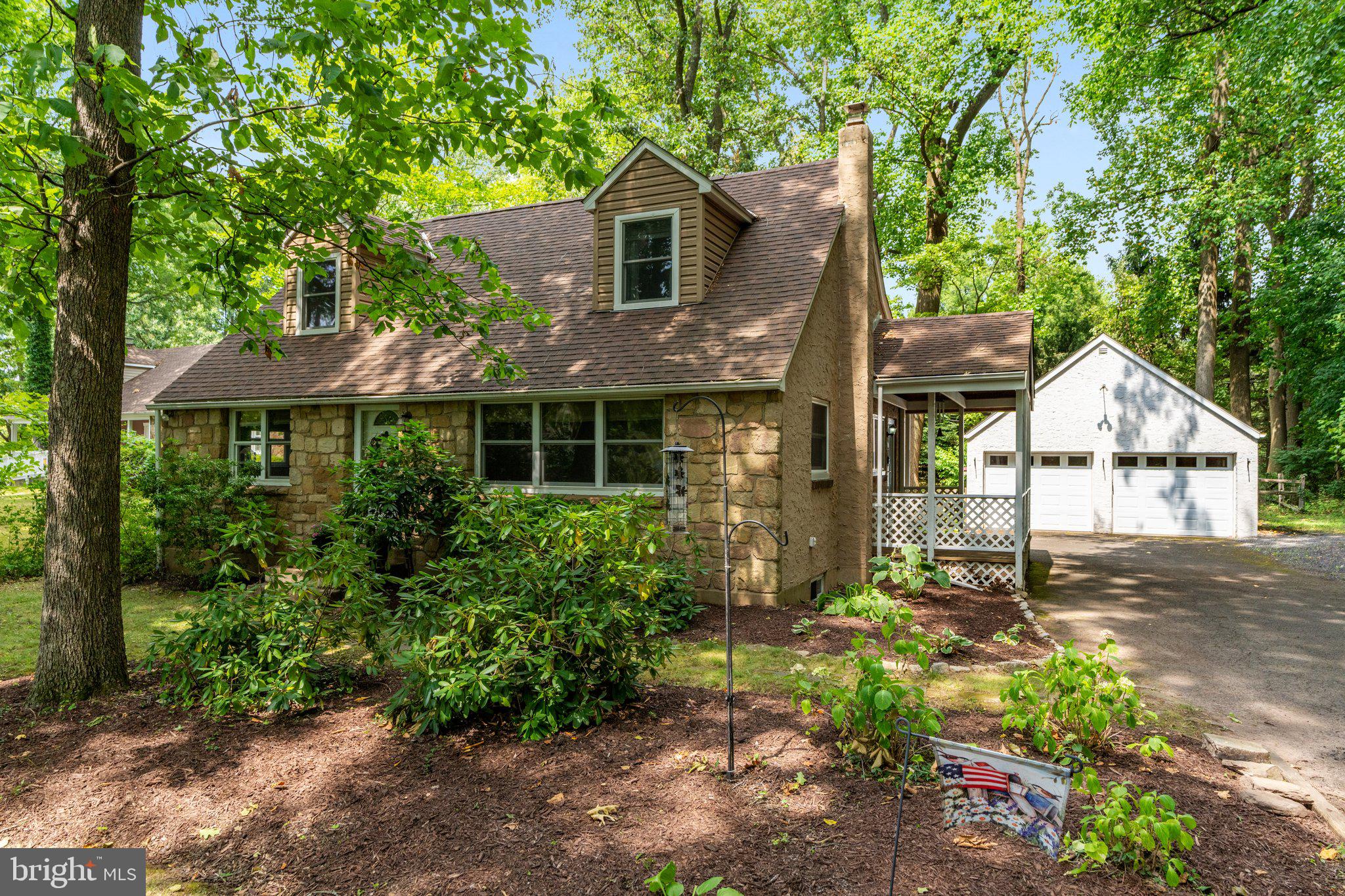 Welcome to this charming home in desirable Maplewood in Doylestown Borough. The delightful neighborhood is filled with history and dedicated to our local war heroes with streets that commerate their names and it's own memorial area. Close to the borough of Doylestown, playground and ball fields, there really is no place like Maplewood. Tucked away in a quiet setting with close proximity to the playground and ballfields, this classic home features a huge backyard, detached two car garage with accessible storage above and fencing for extra privacy and safety. The large driveway can accomodate many cars and extra parking is a short distance away by the ballfields. The spacious living room leads to the dining room and kitchen and side porch leading to the yard and garage. Wood floors are found in most of the home, ceramic tile flooring is in the kitchen which is open to the dining room. Two bedrooms and an updated full bath are found on this floor, along with the entrance to the unfinished basement with laundry and bilco doors. The second floor of this home is the setting for two nicely sized bedrooms, including the primary bedroom with two closets and a small sitting area. An updated hall bath serves these two additional bedrooms. Many new improvements to this home including updated windows in most of the home (front dormer windows are not new),  2 year old sump pump, new bilco doors (2015) and water heater in 2022. Newer appliances in the kitchen and a home warranty is included for peace of mind. This home is beautifully maintained and ready for the next owner. This is a great find in a highly desirable neighborhood. You will feel like you have the greatest privacy in the oversized yard while still being part of a vibrant neighborhood so close to town and shopping. Don't miss your chance to visit and see this lovely home that is ready for quick occupancy.