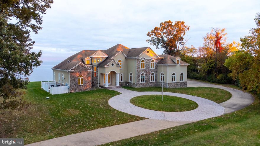 Welcome to your private river getaway!  This stunning, custom built home sits on 3 + acres with over 900 feet of waterfront, located on a point along the Potomac river, offering breathtaking views of the sun rising over the water.  Every detail of this home was carefully thought out while it was being built.  There is intricate, custom tile work in every single bathroom and throughout the home, including the expansive outdoor shower.  There are concrete steps at the shoreline that take you down to your very own sandy beach, where you can relax or go for a swim.  There is also a shaded boardwalk through the trees down to your pier, where you will find your private boat lift and  jet ski lift.  When you're done enjoying the river,  you can kick back and enjoy a drink at your private bar or balcony located on the second floor, while continuing to enjoy your river views.  Then you can take the elevator down to the main floor and cozy up next to the fireplace, either in the family room or the primary bedroom.  This property is exquisite! Schedule your private tour today to appreciate this home in person. In the meanwhile, be sure to check out the showing tour video, virtual tour AND the photographs!