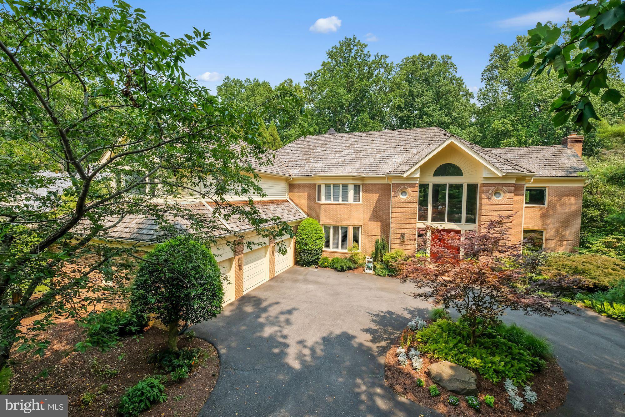 Situated on a quiet cul-de-sac in the coveted Avenel neighborhood, 7017 Mountain Gate Drive is set back on a large, almost 1 acre lot. This updated 5 bedroom, 5 full bath and 3 half bath home has been meticulously maintained and features hardwood floors, 4 fireplaces, built-in whole house speaker system, three-car garage, and a whole house generator.
The impressive two-story marble entryway leads to a step-down formal living room and has access to the oak-paneled library with fireplace. The gourmet kitchen, renovated in 2011, with top of the line appliances, a large center island, and breakfast area is open to the light-filled family room with fireplace. A dining room, two powder rooms, large walk-in pantry, and laundry room complete the main level.
The second level has 4 bedrooms, each with an en-suite bath and generous closets. Included on the second level is the notable primary suite with fireplace, sitting area, two walk-in closets, dressing area, large primary bath and exercise room.
The fully finished lower level includes an extensive recreation room with fireplace, built-in bar with beverage refrigerator, and generous closets and storage space. A bedroom with en-suite bath, office with French doors and a powder room round out the lower level.