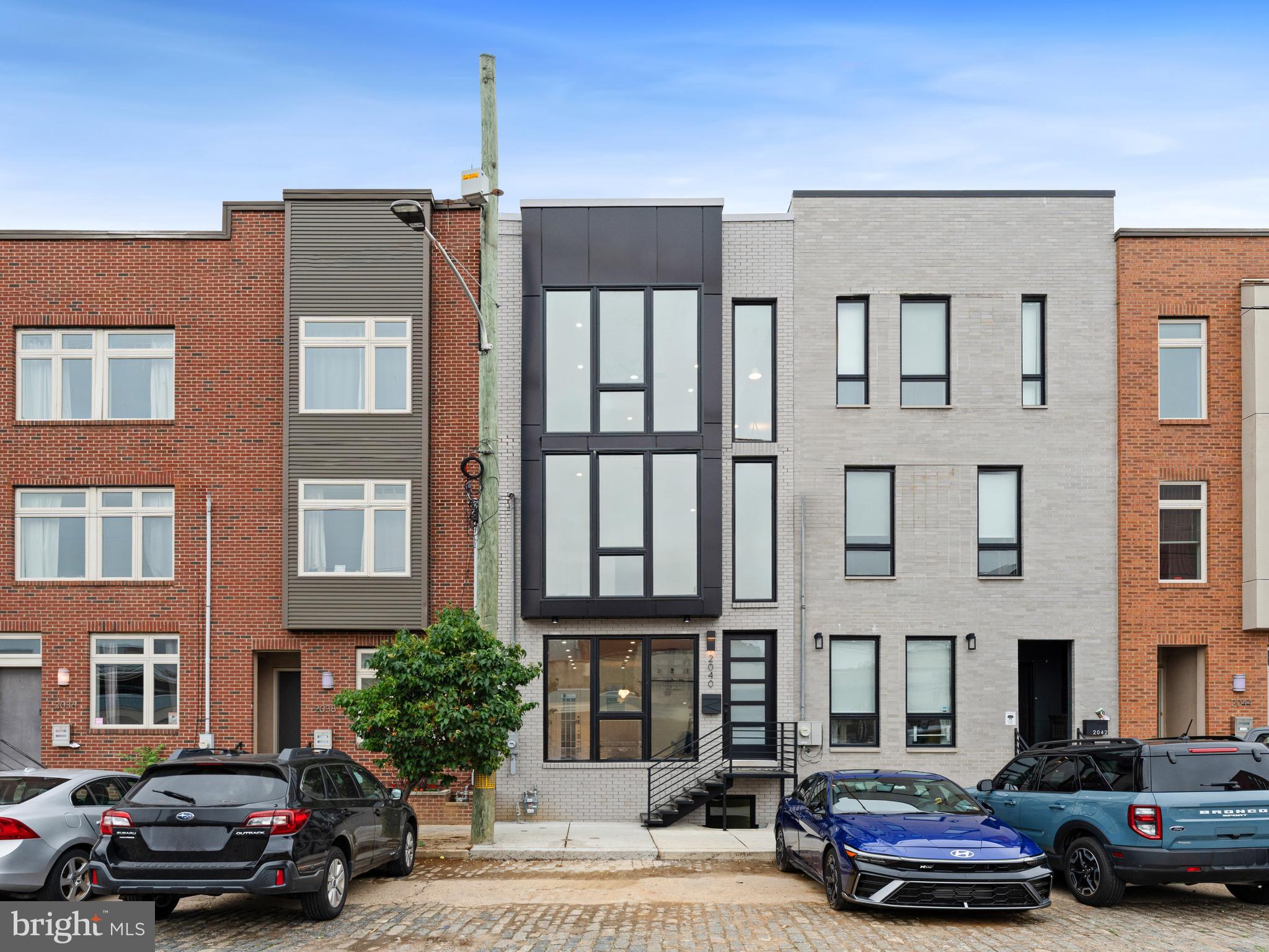 Location ! Location ! Location ! Stylish 4bd x 3baths NEW CONSTRUCTION residence with modern style finishes right in the hart of Fishtown. Beautiful historical wide cobblestone street with full of new homes recently built. Large, landscaped yard with unique black metal fence all around and decorative concrete patio in combination with stones. The oversized windows of this house simply flood the interior with breathtaking natural light, enhancing the space with warmth, elegance, and uninterrupted views that blur the line between indoors and out. Main floor features open concept with gourmet kitchen, engineering wood floors, fireplace, recessed LED lighting and open concept staircases. Guest bedrooms on 2nd floor share a full bathroom. This floor also has a laundry room, equipped with LG washer / steam dryer and second HVAC mechanical room. Entering in master suite you are getting in the dream. Here you will find everything that you need for full relaxation. Huge size bedroom with accent wall and decorative fireplace, 3 great sized walking closets, and the master bathroom with luxury size shower, high level fixtures and modern tile work. A custom bar area leads to the expansive roof deck The roofdeck has multiple areas for outdoor entertaining and sweeping skyline views. Full basement includes full bathroom, office and a bedroom. ALL bathrooms have frameless glass showers, providing an elegant touch. TAX ABATEMENT APPROVED !!!. 1-year builder warranty. Walk to world-class restaurants, bars, amenities, plus a vibrant mix of coffee shops, gyms, boutiques, and nightlife. Destinations like Mulherin's, Loco Pez, ReAnimator, LMNO, La Colombe, Picnic, Kalaya, Murph's, Hiroki, Frankford Hall, Suraya + more. Easy walk (less than 10min) to SEPTA Market-Frankford El train station connecting riders directly into Center City and University City Philadelphia. And I-95 providing quick commutes to the airport, New York, or New Jersey.
Come, See and Fall in Love ..........