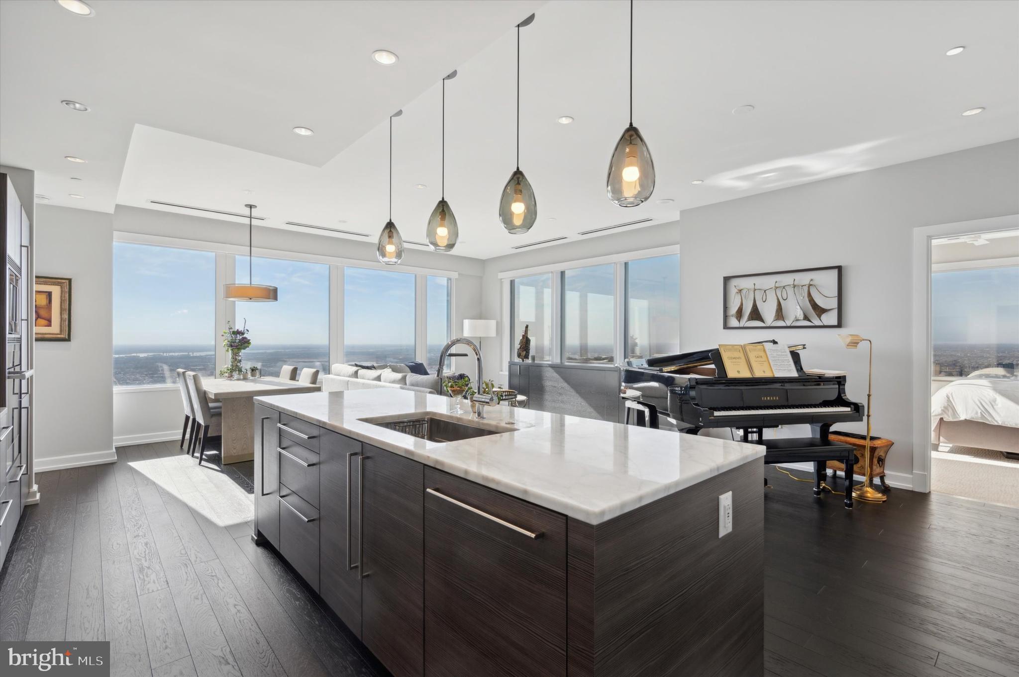 Welcome to #5001-02 at the iconic, renowned 'Residences at Liberty Place'! This is a unique combined unit featuring extensive upgrades and customizations in one of Philadelphia's most exclusive residences. Situated in the heart of Center City, this exceptional home offers breathtaking panoramic views, unparalleled luxury, and an unbeatable location. At almost 2500 square feet, this high-floor gem is a rarity and the epitome of sophisticated urban living.
As you step into this meticulously designed space, you are greeted by gorgeous hardwood floors and wall to wall windows that flood the open-concept living area with natural light, showcasing stunning eastern, southern AND western views of the Philadelphia skyline, Rittenhouse Square, the Delaware and Schuylkill Rivers, and beyond! Breathtaking sunrise and sunset views!
The modern, chef-inspired kitchen features top-of-the-line Miele appliances, sleek wood cabinetry, quartz countertops and a spacious island perfect for both casual dining and entertaining. The expansive living and dining area is perfect for hosting guests or enjoying quiet moments while overlooking the city and includes custom remote-controlled blinds, an ascending TV stand, and custom built-ins housing both refrigerated and unrefrigerated wine and beverage storage.
The primary suite is a true retreat and includes a bedroom with custom blinds, ceiling fan and divine panoramic views, a gorgeously curated oversized walk-in clothes closet with custom organizers, an additional walk-in shoe closet, linen closet- and finally a spa-inspired en-suite bathroom featuring a double vanity, a luxurious frameless glass walk-in shower and a deep soaking tub for full relaxation. The second bedroom is equally as inviting with convenient custom built-ins surrounding the bed/desk nook, a walk-in closet and an en-suite bathroom with a stall shower. The third bedroom (which is currently being used as an office) has stunning south-facing views, floor-ceiling built-ins and also includes a walk-in closet and en-suite bathroom. The most special and unique feature of this flat is that it includes an additional wing complete with a designated office space, dual custom storage closets, AND a second oversized living space (aka the 'zen den') with fireplace. From rich custom built-ins, to the fireplace, to the dreamy sunset and skyline views- this room is arguably the most luxurious of all. It's a peaceful and beautiful place to relax, or entertain. Other notable features of this unit include an additional full bathroom which serves as the powder room, in-unit laundry (washer and two dryers), recessed lighting throughout. The unit has a custom designated wet-bar room, traditional foyer with coat closet, 4 HVAC zones, and two storage units.
Residents of 50 S. 16th Street enjoy a range of luxury amenities. The extensive amenities floor located on the 37th floor was completely renovated and completed in 2024. The amenities floor includes an extensive fitness area, yoga studio, spa area with private massage room, sauna and steam rooms, caterers kitchen, billiard room, media room, two conference rooms, business center, and gorgeous lounge where you might find yourself at the 2Lib book club or at an Eagles watch party. The building provides 24/7 concierge service, complimentary house car service, secure valet parking and more! With world-class dining, shopping, and cultural attractions just steps away, this spectacular upper floor unit offers the ultimate in both comfort and convenience.
Don’t miss your chance to own this exceptional piece of Philadelphia real estate. Schedule your private tour today!