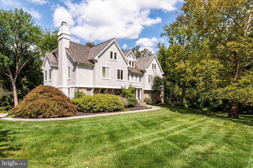 Welcome to Thornbrook — a light-filled, beautifully updated home in the heart of Bryn Mawr. Offering 5 bedrooms, 4.5 baths, and a flexible floor plan, this residence is thoughtfully designed for comfortable daily living and effortless entertaining.

Enter through double doors to a dramatic two-story room — currently appointed as a dining room but equally suited for a family room, entertaining space, or other use to fit your lifestyle — with doors opening to an oversized wraparound deck. Off the foyer, the spacious living room with fireplace creates a warm, welcoming setting. A bar/butler’s pantry connects the living room to a private study (optional 6th bedroom) with a full bath.

The dining/kitchen zone flows into a bright eat-in kitchen, mudroom, and powder room. Just beyond, the family room features a second fireplace and custom built-ins, offering a cozy spot to relax.

Upstairs, the primary suite occupies its own wing with a generous bedroom, large walk-in closet, and beautifully updated en-suite bath. Four additional bedrooms and two full baths provide abundant space for family and guests. A large walk-up attic offers potential for a gym, playroom, or additional flex space.

The finished lower level includes a fireplace, ample storage, and room for recreation or work. Additional highlights: 3-car garage, cedar roof, new heater and A/C, whole-house generator, and remodeled baths — all updated in 2019.

Designed by Neil Rambert, Architect, Thornbrook combines timeless architectural integrity with modern livability. Rambert’s practice begins with an “architectural history” study to ensure each home harmonizes with its setting while meeting contemporary lifestyle needs. Known for blending scholarship with practicality, his work seamlessly integrates classic Main Line character with fresh, functional design.

Conveniently located near top schools, major roadways, shopping, and dining, this home blends architectural pedigree with thoughtful updates in a prime Bryn Mawr location.