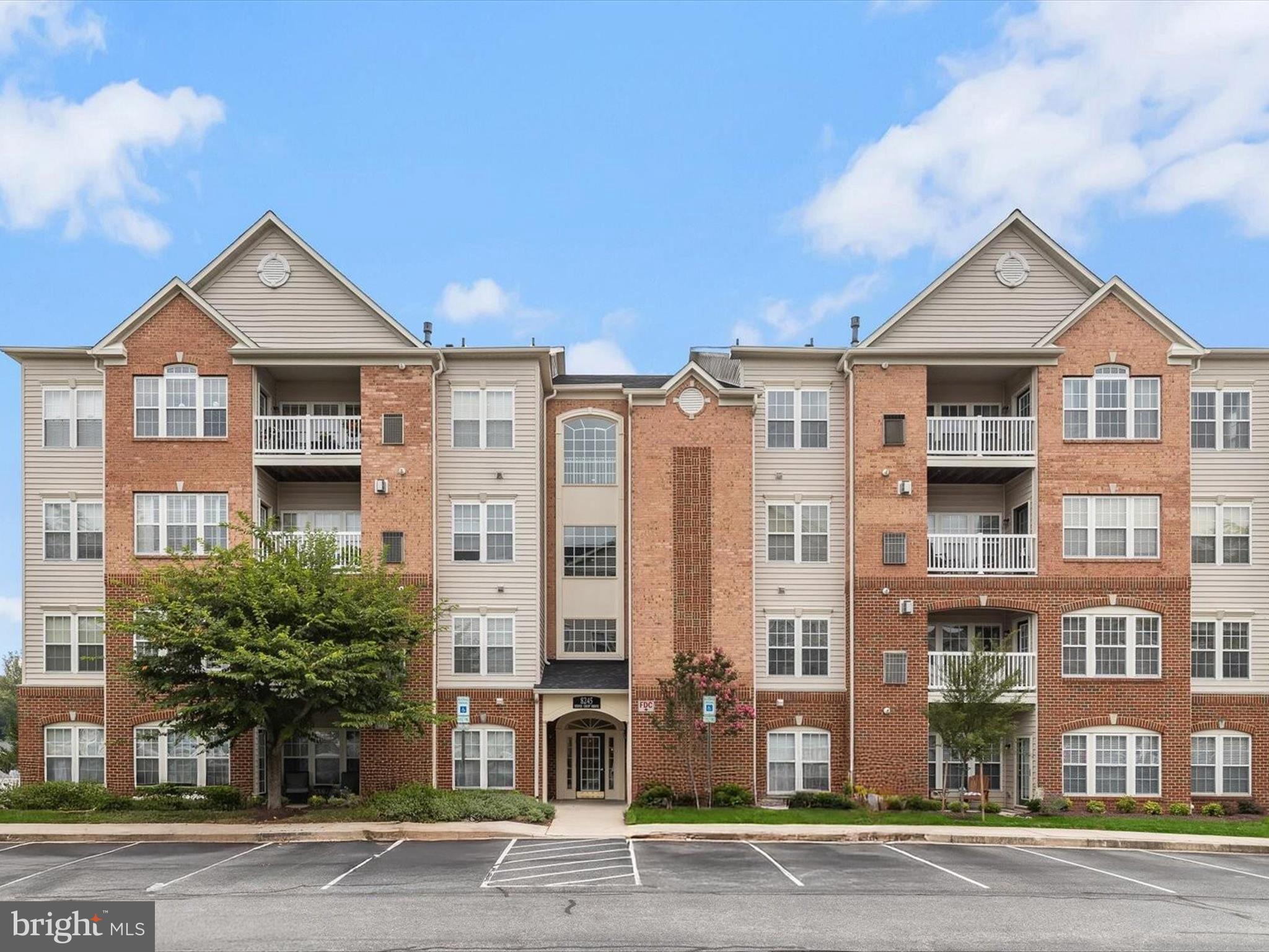 Welcome to 8245 Stone Crop Drive, Unit R, a stunning top-floor condominium in the amenity-rich 55+ community of Hearthstone at Village Crest in Ellicott City. Soaring vaulted ceilings, abundant natural light, and an open, airy floor plan create a truly impressive living space. The inviting living room is enhanced by dramatic ceilings and a cozy fireplace, while the dining room is framed with classic moldings. The chef’s kitchen offers 42-inch cabinetry, stainless steel appliances, a pantry, and a sunny breakfast room with direct access to the private balcony. The primary suite is a serene retreat, featuring a sitting area, walk-in closet, and a spa-like bath with a dual vanity, glass-enclosed shower, and linen closet. A second generously sized bedroom, full bath, laundry area, and ample storage complete the interior. Recent HVAC & Hot Water Heater Replacement. Residents of Hearthstone enjoy plentiful parking and access to outstanding amenities, including a clubhouse, pool, tennis courts, fitness center, and meeting spaces. Ideally located just minutes from downtown Ellicott City, US-29, MD-103, and the Long Gate Shopping Center, this home offers both comfort and convenience in a vibrant community.