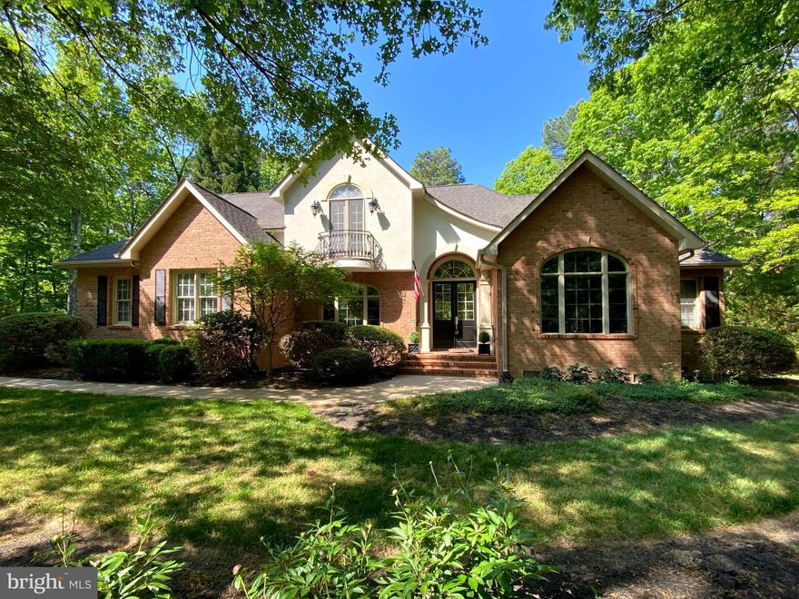 Located inside the luxurious gated Fawn Lake Community, this Gorgeous French Country Residence captures timeless elegance and grandeur from every angle. 
Built by the renowned Sandy Sagun, this custom solid brick Dream Home with a gorgeous exterior facade, complete with a Juliet Balcony and a stunning front door  features a sunlight interior graced with timeless architectural details, solid Oak hardwood floors, rich mouldings, archways, built-ins, and artfully curated living spaces filled with abundant comforts and beautiful design elements throughout.  Offering a beautiful and flowing floor plan with a desirable main level Owner's Suite and charming spaces for elegant yet casual everyday living and entertaining.    
Exuding curb appeal, this Residence is perfectly nestled on a .68 Acre lot filled with lush landscaping and an array of flowering shrubs and the most beautiful flowering trees highlighting the exterior of the property. Sited in a very desirable established area, along a scenic Cherry tree-lined sidewalk, just a stroll to the pool, beach, tennis courts, driving range, and the Fawn Lake Country Club Restaurants! 

Stepping through the custom double front doors, an elegant two-story Foyer with stunning archways and diamond pattern black and white marble floors welcomes you, and sets the tone from the moment you enter.   An elegant Dining Room with tray ceiling and stately columns offers the perfect setting for formal gatherings. The beautiful Den with vaulted ceilings features custom-built Bookcases and tall Palladium windows, inviting brilliant sunlight.  
The spacious Family Room features a stunning Fireplace anchored by built-in media cabinetry, and a wall of windows and French doors leading to the deck and peaceful backyard.
The Gourmet Kitchen with Maple cabinetry, and a center butcher top island offers plenty of space to prepare and cook meals. The cozy Breakfast nook with large windows offering views of the backyard, features French doors leading to the Screened Porch and the rear deck. 
A true sanctuary, the expansive Primary Suite features two walk-in closets, a spa bath with double vanities, tile shower and a soaking tub for relaxing. 
The upper level includes Three gracious Bedrooms with large windows, walk-in closets, and a shared Full Bath with dual sinks. 
With unlimited possibilities, the unfinished Basement offers an additional 1,500 SQ FT of space for storage and future expansion!
The backyard sanctuary offers an idyllic space for extended outdoor living and entertaining, a screened porch and spacious deck with with a wisteria covered arbor are ideal for alfresco dining, lounging, and taking in the sights and sounds of nature. 
An oversized 2-Car Garage and extended driveway provide ample parking. Recent updates include:  Water Heater, Sump Pump, washer and Dryer - 2019. HVAC - 2014 . Live with ease in this well appointed and thoughtfully designed architectural gem that fuses luxury and sophistication with tranquil living.  
Come experience what the Fawn Lake lifestyle is all about where every day is a vacation! 
The luxury and vibrant Fawn Lake Community offers amazing amenities such as a boating recreational lake, sandy beach, an Arnold Palmer Golf Course, pickleball and tennis courts, baseball and soccer fields, dog park, volleyball courts, walking trails, Community ClubHouse, marina, fitness center, restaurants, Country Club, playgrounds, and more!  With an array of clubs, groups and daily activities, you will have plenty of opportunities to join the social scene, make new friends and remain active! Located in the countryside near the town of Fredericksburg, surrounded by park lands and only a few miles to the farm market, wineries, and award winning breweries! Conveniently located to shopping, restaurants  and top-rated Riverbend District schools and I-95!