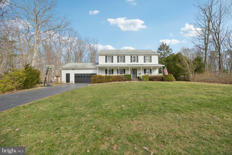 Impressive Colonial Home in the Quiet Bren Forest Community with Top-Rated Schools

Located in the peaceful and sought-after Bren Forest community, this exceptional colonial home offers not only serene surroundings but also the trifecta of excellent schools: Colgan High School, Benton Middle School, and Marshall Elementary. Surrounded by vibrant landscaping, flowering shrubs, and tranquil woods, this home provides a private retreat with a large deck, a charming playhouse, and a stone patio, new fence in 2022, ideal for outdoor entertaining or quiet relaxation. The expansive front porch is the perfect place to watch local wildlife, including deer, as they roam the area.

Inside, the home features stunning hardwood floors throughout the main and upper levels, with durable vinyl flooring in the lower level and hardwood in the kitchen and breakfast nook. Key updates include a new roof in 2009, an upgraded HVAC system in 2013, air handler 2024, and a new well pump in 2017. The septic tank was pumped in 2020, well tank upgraded to 30 gallons in 2024, and the septic field is approved for four bedrooms.

The spacious front-loading garage is built with an extra 6 feet of width and has direct access to the finished basement. A bright and airy sunroom, with 17 double-pane windows and 4 skylights, offers the perfect space to entertain while enjoying views of the gardens and woods. The home is equipped with double-pane windows throughout, featuring attractive wooden sash frames.

The renovated gourmet kitchen features  “soft-close” cabinets and drawers, complemented by sleek quartz  countertops. The adjacent half bath conveniently houses the laundry area, and the washer and dryer are included. The main-level bedroom, with a large closet, could also be used as an office or den.

Upstairs, the spacious primary bedroom boasts hardwood floors and an en-suite bathroom with a stall shower, walk-in closet, and a large cedar closet. Two additional generously sized bedrooms with stunning hardwood floors share a full hall bathroom with a tub and shower combination.

The finished basement offers additional living space with a large recreation room, a workshop, and a storage room, plus stairs leading directly to the garage.

This beautiful home is the perfect combination of indoor and outdoor living, complemented by its prime location within the top-rated school district. Don’t miss out on the opportunity to make this exceptional property your own!