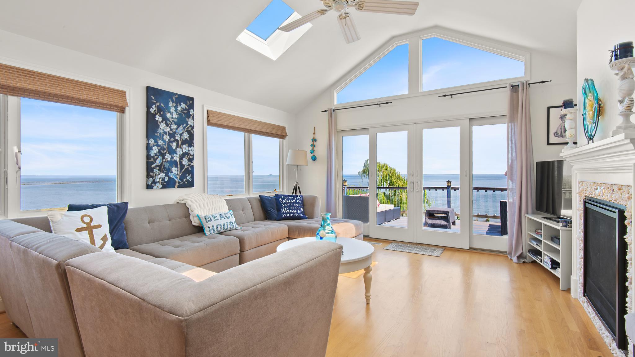 Spectacular sunrises over the Bay! This shorter or longer term rental vacation home offers 180 degree views of the Bay, boardwalk, DT North Beach, etc! Open floor plan with 9 foot and cathedral ceilings! Gourmet kitchen with granite counters, large center island and opens up to the livening room with cathedral ceilings, walls of windows & skylights! Gas fire place too! Double opening slider opens to the spacious deck with amazing views! Finished walk out basement too with family room, bed- & full bathroom, patio and hot tub! Lots of windows & light in the lower level too! Recessed lighting and fresh neutral paint colors throughout. Boardwalk access is a few houses down the street. Take boardwalk; right to Brownies Beach & left to end of boardwalk; then walk up to and take a right on C St to Chesapeake Beach Resort, Rod & Reel, Marinas; with boat, kayak, paddle board & bicycle rentals, Shops, Restaurants, Tiki Bar, Water Park, Hiking Trail, Bank, Post Office, Library, Verizon store, Hair & Beauty salons, McDonalds, Subway, etc! Some of my favorite local restaurants in Chesapeake Beach are; The Rod & Reel, Boardwalk Cafe & Tiki Bar, the new 1936 Restaurant with really nice canal & coastal water views & Bay Front Baia Coastal Italian Kitchen & Wine Bar, with tiki bar & rooftop dining! North Beach; The brand new Sliders restaurant with big wrap around porch, Hook & Vine fine dining, The Wheelhouse Beer & Wine Garden with heated patio & live music. I also love Ketch22 restaurant & tiki bar at Herrington Harbour Marina & Resort; with nice marina & pool views. My favorite dish is pork tacos in lettuce wrap. Chesapeake Beach Resort Spa boat, jet ski, bicycle, kayak & paddle board rentals at Marina West. Also fishing tours are organized out of the Chesapeake Beach Resort & The Rod & Reel! Vacation life style all year round!! : )