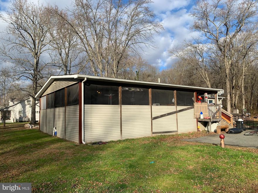 INVESTOR OPPORTIUNITY!! Cute 2 bedroom, 2 bath Rancher that sits on a total of .69 Acre. Home includes 3 lots. Gas fireplace, large walk in master closet, recess lighting. Wrap around screened in porch. Public water and sewer, walking distance to town and park. HOME IS A MUST SEE. Floor plan available upon request.