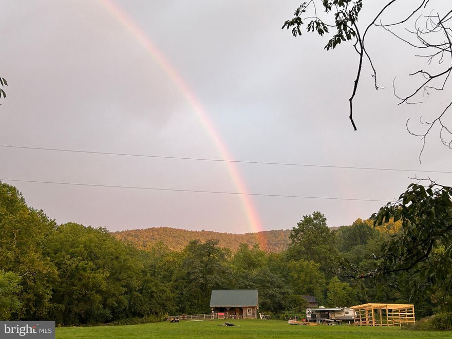 Beautiful  parcel of land at intersection of Gid Brown Hollow and Harris Hollow. Take Gid Brown Hollow towards Sperryville, or Harris Hollow to town of Washington. Peaceful, quiet, accessible, about half woods, half pasture. Well-built structures, one open sides with enclosed, heated area housing pressure tank, etc. Other building, two stories, completely enclosed, wiring and plumbing in place.