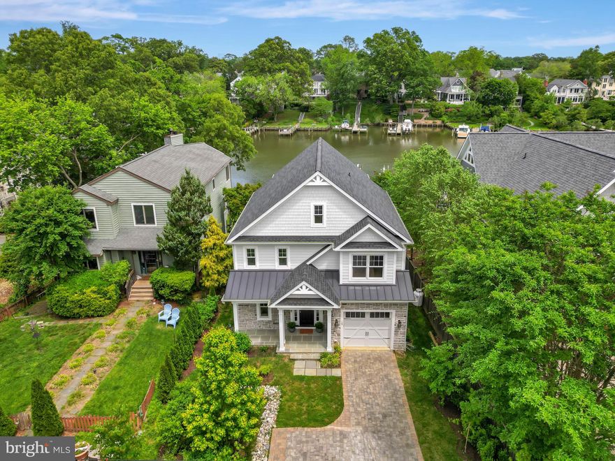 Welcome to 139 Spa Drive – A Stunning  Waterfront Craftsman Home on Spa Creek!

Update to public records - Use and Occupancy issued in 2025.

Experience the best of coastal-inspired living at this beautifully designed,  single-family home located directly on Spa Creek.  This exquisite residence offers three fully finished levels, each with expansive walls of windows that flood the home with natural light and showcase breathtaking water views.

The open-concept layout is ideal for both entertaining and everyday living. A gourmet kitchen sits at the heart of the home, complete with custom shaker cabinetry, quartz countertops, a stylish tile backsplash, premium Bosch appliances, and an oversized center island that offers ample seating and storage. The adjacent Great Room features a cozy gas fireplace and opens to a large waterside deck—perfect for enjoying the serene surroundings year-round. 

Upstairs, the luxurious primary suite offers a tranquil escape with its own private balcony overlooking Spa Creek, a second gas fireplace, and a spa-like bathroom featuring a double vanity, freestanding soaking tub, frameless glass walk-in shower, and a linen closet. The expansive, under-finished walk-in closet is a blank canvas offering endless potential to perfectly reflect your personal style and become a dream space. Two additional generously sized bedrooms each have their own beautifully appointed en suite bathrooms, and a convenient second-floor laundry room adds everyday ease.

The lower level offers approximately 1,300 square feet of finished living space, including a bright and spacious walk-out family room plumbed for a future wet bar, a full bath, an egress fourth bedroom, and two storage areas. The recreation space opens to a stone patio and professionally landscaped yard—ideal for hosting or relaxing in style.

Built with lasting quality and exceptional craftsmanship, this home features 2x6 framing, Hardie Plank siding with stone accents, Anderson high-efficiency windows, and a durable standing seam metal roof. Inside, you’ll find 9-foot ceilings throughout, solid wood interior doors, engineered hardwood floors, and detailed architectural millwork. Outdoor features include a bluestone front porch and rear patio, a paver driveway, and professionally designed landscaping. The home is equipped with three heating and cooling zones, a propane tank servicing both fireplaces and the kitchen range, and a full-house sprinkler system with recessed heads.

Whether you’re an avid boater or simply cherish the tranquility of waterfront living, this home delivers a rare combination of elegance, comfort, and direct water access. Enjoy your private, fully outfitted 90-foot slip with a 16-foot width, 54-foot finger pier, and 220-foot platform, and a mean low water depth of 4.5 feet—making this an unparalleled waterfront offering.