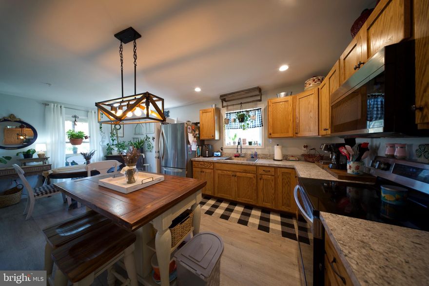 Live the American Dream in Crisfield, Maryland!
This beautiful 3-bedroom, 1-bath New Build sits on a spacious corner lot—nearly an acre of country living at its finest! With 1,092 square feet of thoughtful design and cozy charm, this home checks all the boxes for curb appeal and comfort.

Step inside to a bright, inviting interior featuring custom Mennonite-built kitchen cabinets, complemented by modern appliances that blend seamlessly with the design. The living room offers the perfect gathering space, centered around a stunning tile fireplace—a true conversation starter.

Down the hall, you’ll find a stylish in-closet laundry area, along with a barn-door accented bathroom complete with a tiled shower and elegant mirror—bringing a touch of rustic charm with modern finishes. Each of the three bedrooms includes separate mini splits in each room as well as Ceiling fans and closet space for storage and comfort.

Outside, enjoy the screened-in porch, a handicap-accessible ramp, and a fully encapsulated crawl space that is 5 1/2 tall with electric  lighting and ample storage in the crawl space, Piping under the home has been sprayed with insulation foam. All Plumbing and HVAC as well as electrical wiring is brand new only 1.5 years old! As well as new roof only 1.5 years old!! A Brand new septic,  And for animal lovers—yes, the beautiful goat pen conveys with the property, ready to welcome your furry family members!

Whether you're starting fresh or looking to settle into something peaceful and move-in ready, this home offers country charm with modern upgrades. Don’t miss your chance to experience Crisfield living—schedule your private tour today!