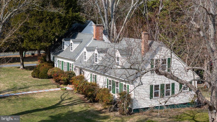 New Price ***This Lovely property known as "Sunnyside" as written and listed in "Where Land and Water Intertwine" An Architectural History of Talbot County, Md. This home has been lovingly updated and improved with a collection of 19th C furnishings and artwork. The home retains many features that show the history yet lends itself to modern living. The previous owner improved the property with a spacious first floor Primary Wing off of the Living Room adding much comfort to this property. The huge open kitchen with it's generous sitting room makes for a very private retreat on the first floor. 
Up 2 separate staircases are a series of 3 rooms that serve as sitting room, office and additional sleeping space for guests . On either end of the Upstairs are 2 generously sized Guest Rooms. In addition there is a second floor Full Bath.
The large 6 acre lot includes a Swimming Pool with views to the River and your Private Dock. In 
addition there are 2 Barns, which one serves as your garage with additional storage.
The owners have recently replaced roof and gutters.Updated Ductless mini split systems and a new well have been installed in recent years.
Travelers Rest is a Very Private community centrally located off of the St. Michaels Corridor and is a Much Sought After address. A Homebuyers Warranty to be provided by Seller.
Please Do Not Enter Driveway without appointment. The Home is occupied. Sellers have chosen their next home and are motivated. Price Improvement !!!
