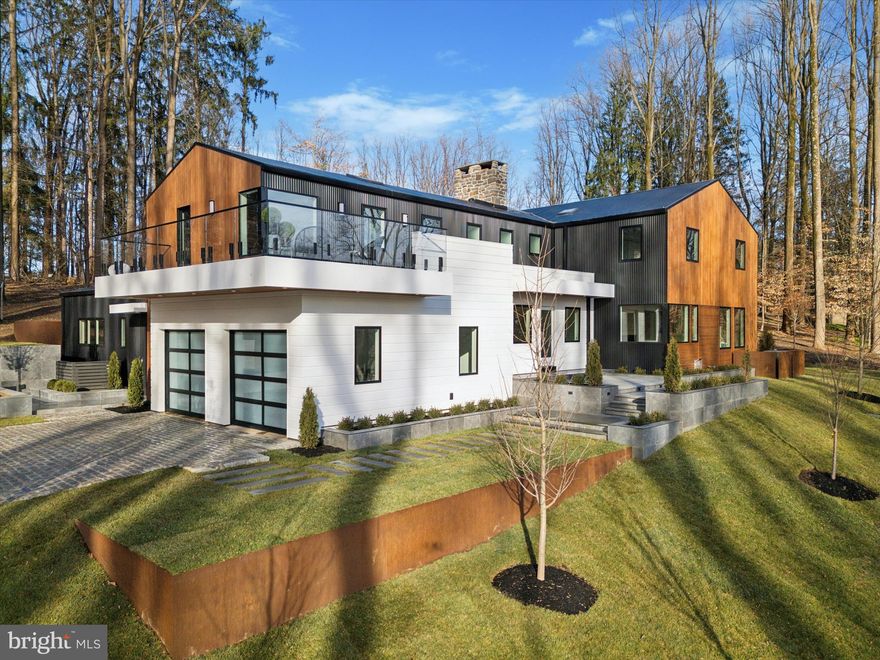 Welcome to 33 Solebury Mountain Road, a newly built masterpiece of modern elegance and contemporary design.  Located in Bucks County, PA, just minutes from the vibrant river towns of New Hope and Lambertville, the five-bedroom residence spans 5,800 square feet across three levels.    
Sited on a gentle hillside, the home offers panoramic views of a seasonally evolving landscape through expansive custom windows flooding the home with natural light.  The exterior is wrapped in clear cut vertical grain cedar and matte black metal, providing a striking contrast to the wooded setting.

The heart of the home is the great room, with a large wood-burning stone fireplace and a wall of glass that opens onto an intimate courtyard carved into the hill.  The great room provides access to an additional living area with a double-sided gas fireplace that is shared with the adjacent dining room. A central open steel and glass floating staircase was custom designed and fabricated on site.  Bathed in natural light from four skylights overhead, it provides access to the upper and lower levels of the home.  

The custom kitchen, which opens into the dining room and offers direct access to the great room, features bleached oak European cabinetry, natural stone quartzite countertops, and a full suite of Miele and Dacor appliances.  A fitted butler pantry, complete with a secondary dishwasher, additional refrigerator, and wine refrigerator, permits the kitchen counters to remain clutter free. 

A side entry to the home provides direct access to a private suite, with full bath, that could serve many potential uses, such as a professional office, home gym, study, or accommodations for guests, in-laws, or an au-pair.

The primary suite, situated at the western end of the upper floor, offers unparalleled privacy and luxury.  It is entered through double doors that reveal a substantial entrance gallery, a sky-lit master bath with a steam shower wet room, and two cavernous walk-in closets. Large windows provide three exposures and captivating sunset views, while a private cantilevered terrace evokes the feeling of a luxurious tree house.  The upper floor also includes a secondary suite with full bath and balcony, three additional bedrooms, an additional full bath, and a fully fitted laundry room.   

The lower level offers additional living space, with a gas fireplace, a wet bar with an icemaker and beverage center, a half bath, large storage areas, and direct access to the leveled side yard, which provides the perfect location for an in-ground swimming pool.

The home is surrounded by thoughtful and strategic landscape design; extensive hardscaping; and multiple terraces.   In addition, the hillside site required the installation of large concrete retaining walls that are faced with a combination of weathering steel and porcelain tile, providing intriguing punctuation to the wooded location. The rear terrace includes a built-in propane grill.

The finishes throughout the home are stunning, with 9-inch white oak flooring; full-tiled Porcelanosa bathrooms; natural honed quartzite and leathered granite; and custom cabinetry throughout. 

This home is a true sanctuary, offering an inspiring lifestyle in a picturesque setting. Experience the elegance and modernity of 33 Solebury Mountain Road, where every detail has been meticulously crafted for a life of comfort and sophistication.