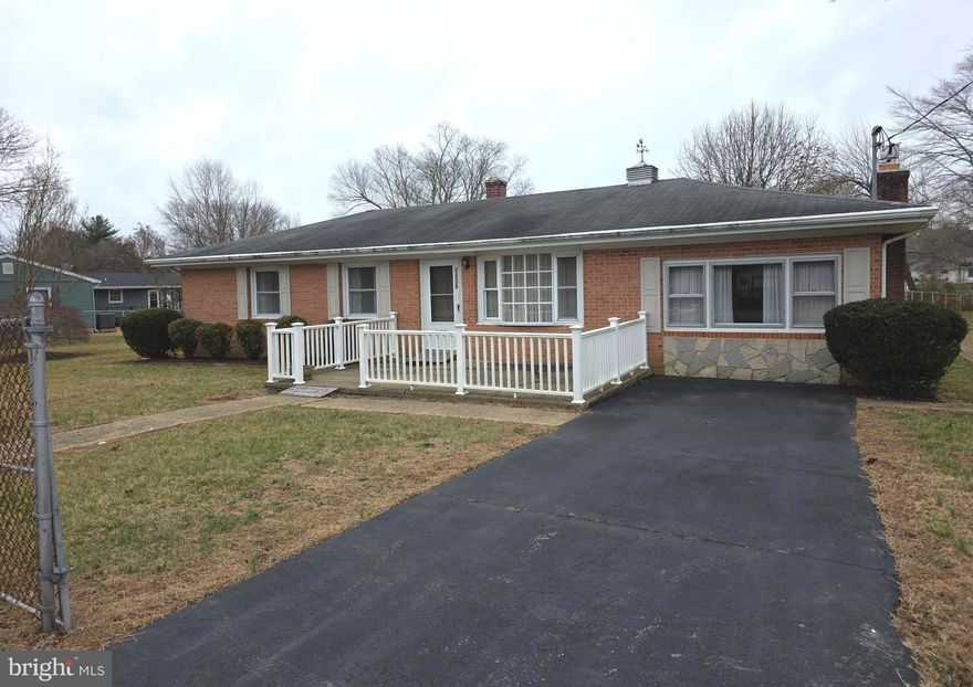 Lovely brick front 3-bedroom, 1.5 bath ranch home nestled on a spacious and level .57 acre fenced lot, with driveway parking, covered patio, and a lush yard and garden shed. Inside, an open floor plan features a living room with a bay window and an opening to the dining room that features a striking chandelier and flows into the well-appointed kitchen. The family room also off the living room boasts a cozy fireplace set in a floor to ceiling brick wall. A laundry room off the kitchen and rear door opens to patio and grassy backyard that is perfect for outdoor entertaining, play and relaxation.  Back inside, the primary bedroom boasts hardwood flooring, a lighted ceiling fan and private half bath. Two additional bedrooms, each with hardwood flooring and lighted ceiling fans and a full bath with tub/shower combo complete this wonderful home.  Located in a quiet residential setting, and just minutes to shopping, dining, parklands and the Chesapeake Bay.