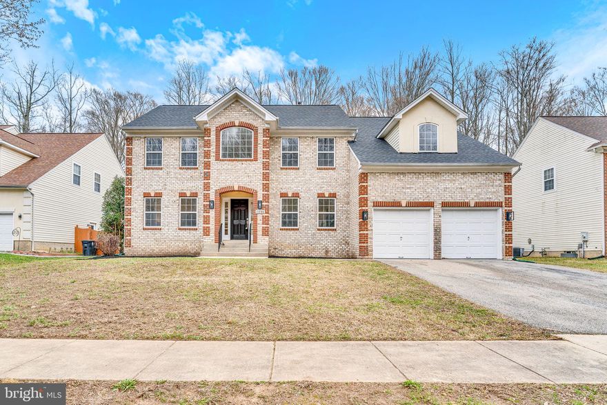 This fully renovated, move-in ready Colonial is tucked away in a quiet cul-de-sac and offers exceptional upgrades inside and out. Featuring a beautiful brick front with decorative two-tone quoins and a front-load two-car garage, this home boasts a brand-new roof, HVAC system, hot water heater, and newly refinished multilevel deck that backs to wooded privacy. Step into a grand two-story foyer and take in the new hardwood floors that flow throughout the main level. The formal living and dining rooms are enhanced by recessed lighting and decorative columns, with a butler’s pantry and wine rack connecting the dining area to the open-concept island kitchen. The kitchen impresses with quartz countertops, 42-inch cabinetry, a built-in desk area, pantry, and new stainless steel appliances—including a five-burner gas range.  The dramatic two-story family room features vaulted ceilings, skylights, half-round windows, a gas fireplace with slate tile and oak mantle, and a designer chandelier. A private office with two closets and access to a second deck provides flexibility as a main-level bedroom. The main level also includes a renovated half bath, laundry room, and 9-foot ceilings throughout. Upstairs, the catwalk overlooks both the family room and foyer, leading to four bedrooms with new hardwood floors and recessed lights. The spacious owner’s suite features a vaulted ceiling with LED lighting, dual walk-in closets, and a show-stopping luxury bathroom with a pedestal tub, oversized glass-enclosed shower with multiple spray heads, and stunning quartz finishes. The upper-level hall bath is fully updated with quartz tile and modern touches, and a new washer and dryer are conveniently located in the upper-level laundry closet. The finished walkout basement includes a rec room with mini bar, fully renovated full bathroom, and a versatile fifth bedroom or theater room with French doors. Simply a must see.