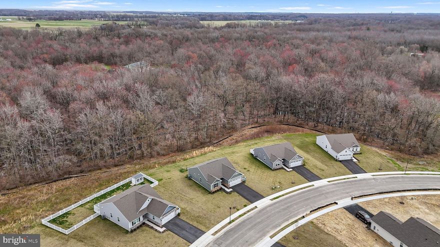 Welcome home to Verona Woods, a highly sought after 55+ active adult community known for its beautifully designed homes, spacious lots, and rare flexibility. This is one of the few communities that allows fences, sheds, and full personalization, giving homeowners the freedom to truly make their property their own.

This beautiful Grand Bahama model is ideally situated on a premium lot backing to a peaceful wood line, offering privacy and scenic views across 27 acres of preserved space. The home features attractive stone front detailing and luxury vinyl plank flooring throughout, along with many thoughtful upgrades.

The upgraded kitchen includes a large island with quartz countertops and an abundance of cabinet space, perfect for everyday living and entertaining. The main bathroom has also been updated with tile flooring, a tiled shower, and quartz countertops. An on demand hot water heater adds efficiency and convenience.

Enjoy low maintenance living in a quiet, well spaced community while still having the ability to personalize your home and outdoor space. Verona Woods offers comfort, flexibility, and a welcoming active adult lifestyle.