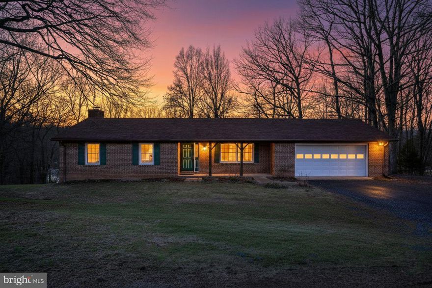 One-level living on 5 private acres with over 3,100 finished square feet—offering exceptional space both inside and out. This 4-bedroom, 3-full-bath home features a stunning 22x30 family room addition with vaulted ceilings, recessed lighting, and gleaming hardwood floors. The spacious kitchen offers abundant cabinetry, generous counter space, a breakfast bar, and breakfast area—perfect for everyday living and entertaining. Main-level laundry adds convenience. The primary suite includes a private bath and large closet, with two additional bedrooms and a full bath completing the main level. Enjoy over 1,000 feet of wraparound decking with gazebo and concrete patio, ideal for outdoor gatherings, plus seasonal mountain views. The freshly painted lower level includes a family room with wet bar, brick hearth fireplace with wood-stove insert, an additional bedroom, full bath, and home office or gym. Oversized 28x28 two-car garage with workshop/storage area, ample driveway space, and room for additional parking. Peaceful country setting close to the Shenandoah River, Andy Guest State Park, hiking trails, wineries, and more. Approximately 1.5 miles to Skyline Drive and just 8 minutes to town conveniences. All paved roads with easy access. Roof is 10 years old.