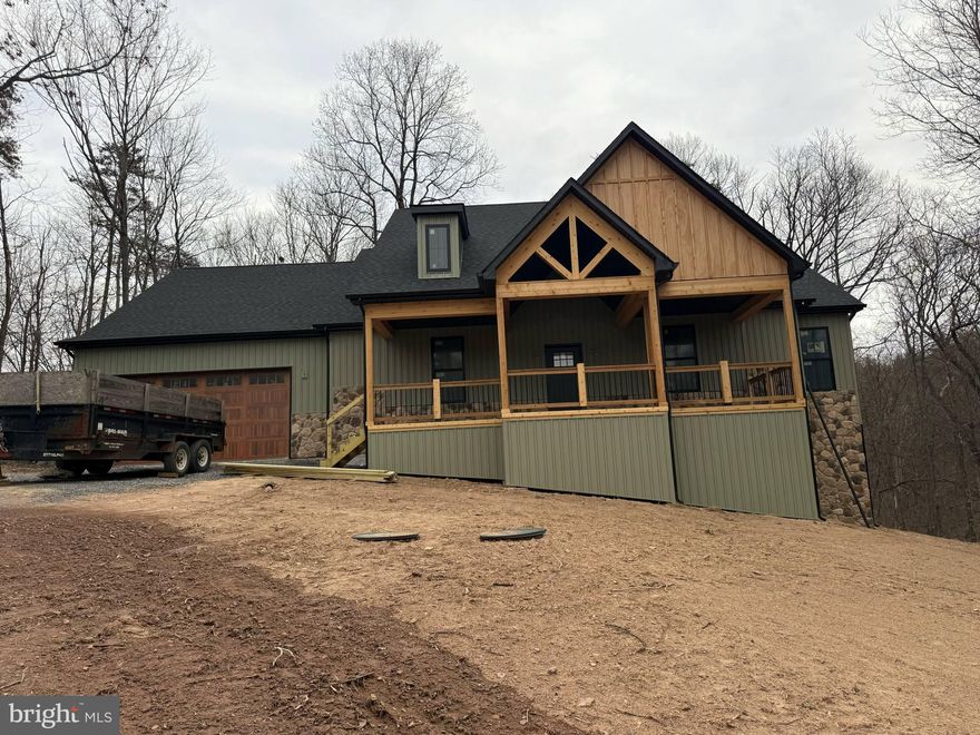 Under Construction in the Sought-After Cacapon South Subdivision!!!! 
This beautifully designed 4-bedroom, 3.5-bath home offers the perfect blend of elegance, comfort, and functionality in a peaceful, wooded setting. The exterior highlights a stylish mix of stone and siding, creating a timeless and elegant curb appeal. Highlighted interior features include a split-bedroom layout with a spacious primary suite that includes dual primary bathrooms — each with its own shower, sink, and toilet. The open-concept living area highlights a partial stone fireplace with shiplap accent, a formal dining room, and a dedicated office complete with built-ins. The kitchen will feature a large island, Quartz countertops throughout, and a stainless steel kitchen appliance package. The engineered hardwood flooring throughout is 1/2 inch bamboo in a grayish brown tone that coordinates with any color palette.
Upstairs, the loft provides an additional bedroom and bathroom. The unfinished basement offers plenty of potential with a walkout to the backyard and includes an unfinished keypad entry safe/gun room for added security and storage. Enjoy outdoor living on the beautiful back deck or relax on the welcoming front porch, surrounded by mature trees for privacy and serenity.
Located directly across from Cacapon Resort State Park, residents can enjoy access to golf, dining, walking trails, and more. The community features paved roads and a tranquil mountain setting, just minutes from downtown Berkeley Springs. Don’t miss your chance to make this incredible new home yours!