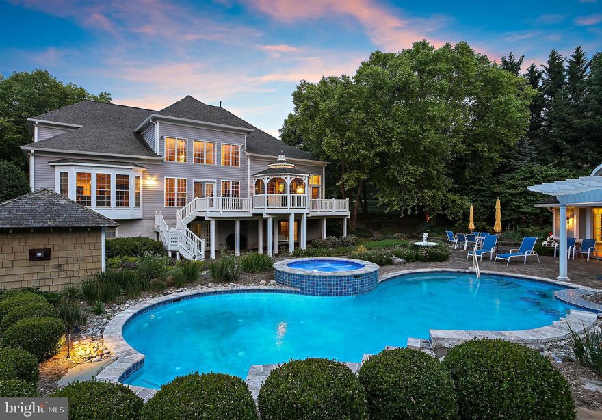 EXQUISITE!  With over 7,000 square feet of elegantly finished square feet, no detail was left untouched in this expansive Glenelg retreat.   Situated on over an acre in The Paddocks, this stately home is perfect even for the most selective of  buyers. As soon as you enter into the main foyer, you are welcomed by custom finishes throughout this home’s ideal layout, with formal spaces for entertaining any number of guests and a gracious, accommodating flow. The two-story living room serves as the centerpiece, with a gorgeous wall of windows and an easy flow into the adjacent kitchen. With gas cooking and finishes that are sure to impress, the kitchen features gleaming granite counters, a walk-in pantry, expansive table space and a sitting area that leads to the exquisite backyard oasis. Indoor/outdoor entertaining flow is a dream with this truly private haven, featuring a gazebo, oversized deck, pristine in-ground pool, patio, pergola, and climate-controlled pool house with full bath, all with beautiful professional landscaping. Back inside, the main level primary bedroom suite with its private, spa-like bath includes two walk-in closets with custom shelving systems.  Completing the main level is the formal dining room, opulent home office with built-in cabinetry, half bath, and laundry room. Make your way upstairs where four massive bedrooms await, each featuring a walk-in closet. The finished lower level provides abundant flexible space to suit whatever your needs may be. This home is outfitted with endless features for your comfort and lifestyle, such as a massive three-car garage,  brick driveway and walkway, lower level in-law suite with full kitchen, fully-equipped home theater, and numerous updates for your peace of mind.  With its location in highly sought after western Howard County, this one is an absolute must-see.