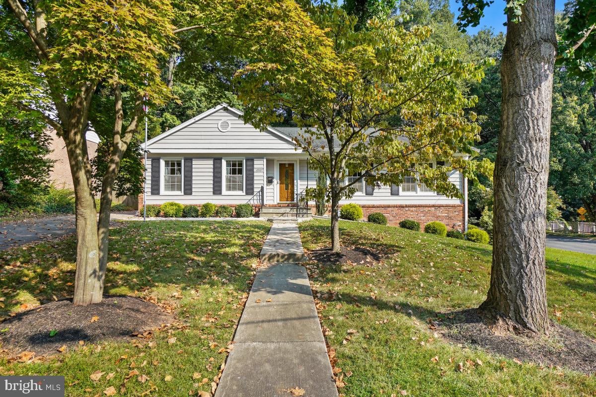 Discover an incredible opportunity in the highly sought-after Regent Park neighborhood! This charming rambler is situated on a beautifully landscaped corner lot, offering privacy with a backdrop of lush trees. The main level features three comfortable bedrooms and two full bathrooms. The updated kitchen seamlessly connects to the family room, complete with a fireplace, perfect for gathering with loved ones. Entertain guests in the formal dining room or relax in the spacious living room. The property also boasts a fantastic recreation room, along with ample storage, a laundry area, and a workshop, all with above-ground windows and a convenient door to the outside. Additionally, there is a large fourth en-suite bedroom on the lower level, providing extra space and privacy. Located near Churchill School and with easy access to highways 495 and 270, this home offers both convenience and charm.
