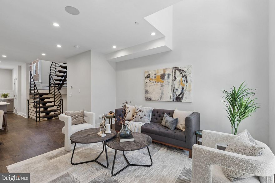This is the one buyers wait for, but rarely find. A five-year-young, 18-foot-wide luxury home that delivers the space, design, and finishes most new construction tries to match.

Step inside and immediately feel the difference. The main level is flooded with natural light thanks to a lofted mezzanine ceiling and dramatic rear switchback metal staircase, creating a true wow-factor from the moment you walk in. The open-concept layout flows seamlessly into a chef’s kitchen built for both everyday living and entertaining - featuring GE stainless steel appliances, Fabuwood cabinetry, quartz countertops, and a large island. Out back, a private rear yard gives you that rare city outdoor space.

The fully finished lower level adds serious flexibility, perfect for a media room, gym, home office, or guest suite. Complete with a full bathroom, storage, and mechanical space.

The second floor offers two spacious bedrooms, generous closets, a full bath, and a dedicated laundry area, all thoughtfully laid out for functionality and comfort.

Then there’s the top floor - an entire level dedicated to your primary suite and private sanctuary. This is where the home further separates itself from the competition. Enjoy two custom walk-in closets, a wet bar, and a true spa-style bathroom featuring a soaking tub, dual vanity, private water closet, and an oversized 5-piece glass shower.

Top it all off with a private roof deck showcasing 360-degree skyline views - your own elevated retreat in the city where you can unwind and relax after a long day's work, or sip a hot cup of coffee early in the morning while gazing at the sunrise.

Additional highlights:

-Dual-zone HVAC
-Custom engineered hardwood floors throughout
-Imported tile finishes in all bathrooms
-Smart home package: Sonos audio, August Smart Lock Pro, Video Doorbell & remote access

Most buyers are choosing between outdated resales or overpriced new builds with compromises. This gives you the best of both, a modern home that’s already dialed in, wider than most at 18 feet, and designed to actually live in. Homes like this don’t sit. Schedule your showing before it’s gone!