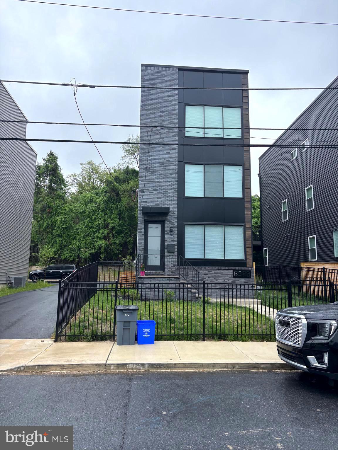 Welcome to this beautiful new contemporary townhome located near Manayunk .This beautiful single-family contemporary residence with a modern design offering an unmatched workmanship with luxury, comfort, and style. With 3 Bedroom and 3 & half bathrooms, and a one-car rear entry garage, this home is perfect for discerning buyers searching for a luxury urban lifestyle. As you enter the front entrance , you will notice the soaring ceilings and with an abundance of natural light from the large modern windows . There is beautiful natural maple hardwood floors that flow throughout the home. The two story contemporary living room is a , features a modern electric fireplace and a sophisticated wet bar, ideal for entertaining guests. The main level also includes a powder room, a laundry area with a built-in sink and quartz countertops, with access to the one-car garage and the backyard. The modern maple staircase, crafted from reclaimed barn wood leads to the expansive open floor plan on the next level. The dining area transitions into a gourmet kitchen, equipped with Level 9 quartzite countertops, state-of-the-art Thor stainless steel appliances, and a six-burner stove. The kitchen has a contemporary center island with quartz waterfall countertops and an additional wet bar .. The large 8-foot by 9-foot sliding doors flood the space with natural light lead out to a beautiful new deck for outdoor entertaining !!!!.The primary suite features large windows that allows a lot of natural light into the room a spacious walk-in closet, with a luxurious en-suite bathroom. The en-suite bath boastes a double sink vanity and an oversized walk-in shower that is sure to impress. An additional bedroom on this level includes a private en-suite bathroom, providing comfort and convenience for guests or family members. The main feature of the home is the expansive 41x17 rooftop deck, offering breathtaking views of the city skyline. The lower level of the home features a third bedroom with an en-suite bathroom, finished to the same high standards as the rest of the home. Ther is dual-zone HVAC for optimal climate control, and integrated audio speakers on the downstairs and main levels.. The property also includes additional parking in the rear and backs onto beautiful woods, providing a private setting.. This townhome is a modern work of art, meticulously crafted with high-end finishes . This home has 2 outdoor areas for entertaining a roof top private deck for entertaining or sunbathing .There is also a brand new deck for entertaining your guests with access from the kitchen ! This beautiful modern home is available for rent now !
