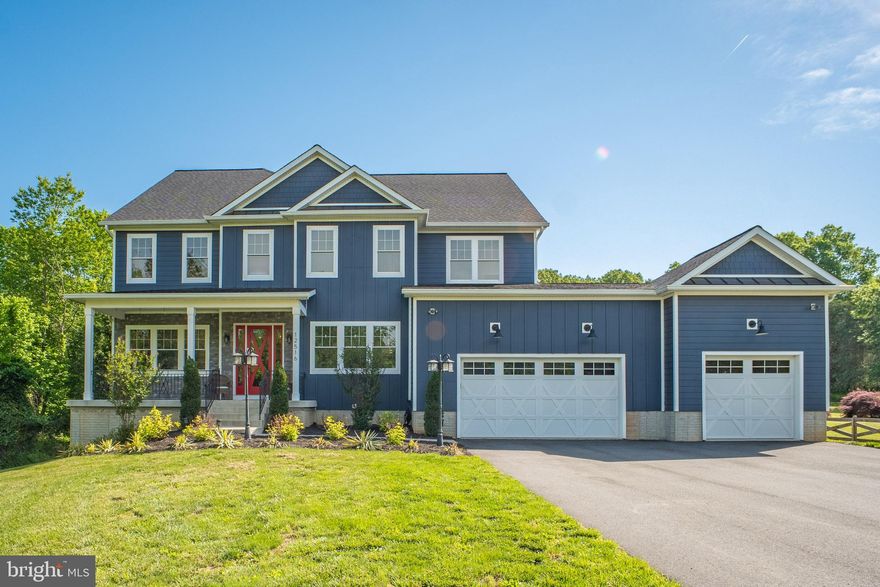 Exceptional Custom Craftsman on 2.51 Private Acres in Nokesville – No HOA!

Welcome to this beautifully crafted 7,472 sq ft home offering 7 bedrooms, 5.5 bathrooms, and flexible living space across three finished levels. Built in 2021 and set on a quiet, tree-lined 2.5-acre lot with no HOA, this property is ideal for multi-generational living or au pair arrangement, a large or growing family, and those who love to entertain.

From the moment you arrive, the home’s curb appeal shines with HardiePlank siding, a welcoming stone accented front porch, and a three-car garage. Step inside to an open-concept main level with luxury vinyl plank flooring, recessed lighting, and crown molding throughout. The light-filled foyer flows seamlessly into a formal dining room with ship lap wall detail, and a dedicated office that connects to the butler’s pantry and gourmet kitchen.

The kitchen is the heart of the home, featuring a granite center island with two-tier breakfast bar, a stainless steel farm sink, farmhouse pendant lighting — ideal for entertaining or casual family meals. Enjoy two-tone soft-close cabinetry, a ceramic tile backsplash, 5-burner gas range with hood, built-in microwave, second wall oven, French door refrigerator, and a walk-in pantry with generous storage. A custom wood ceiling detail and farmhouse pendants add unique character. The kitchen opens to the spacious living room and breakfast room, both featuring ship lap accents and direct access to the 23x15 Trex deck, perfect for al fresco dining & entertaining. The fully fenced backyard includes a playground and serene wooded views.

The main-level primary suite offers a spacious walk-in closet and updated ensuite bath with granite-topped vanity, ceramic tile floors, and a tub/shower combo. Just off the garage entrance, the 18x19 mudroom includes custom built-ins,  raw-edge bench seating, and a large storage closet—ideal for coats, gear, and organization.

Upstairs, the second primary suite (32x26) features French door entry, luxury vinyl plank flooring, two large walk-in closets, a sitting area, and a luxurious ensuite with a soaking tub, dual marble-topped vanities, a custom tile shower with granite bench and dual shower heads, and a separate water closet. Four additional upper-level bedrooms are carpeted, offer walk-in closets, recessed lighting, ceiling fans, and access to two full bathrooms—one ensuite, the other shared. The stylish upper-level laundry room includes ship lap accents, a washer/dryer, and a bonus vanity with sink.

The finished lower level offers endless possibilities with a 42x37 recreation room, rough-in for a wet bar (tile and plumbing in place), two additional bedrooms (non-egress), a full bath, and a second laundry room. The utility area includes a gas furnace, 75-gallon water heater, water pressure tank, water softener, and a sump pump. The second sump pump is located in the closet near the rear sliding glass door. A double-wide walk-up provides easy backyard access.

Additional features include:

    2-car garage (24x22) plus 1-car garage (24x14)

    Zoned heating: propane on main/lower, heat pump upstairs
                                     propane also services the stove and water heater

    Septic inspected 2/2025

    Built in 2021 – everything is like new!

Lot extends approximately 75+ feet beyond the back fence - reserve drain field

This home blends luxury, function, and flexibility in a peaceful rural setting that’s still just minutes from schools, dining, parks, I-66, Rt. 28, Prince William Parkway, and the VRE.

Move-in ready and truly one of a kind—don’t miss your chance to own this extraordinary property!