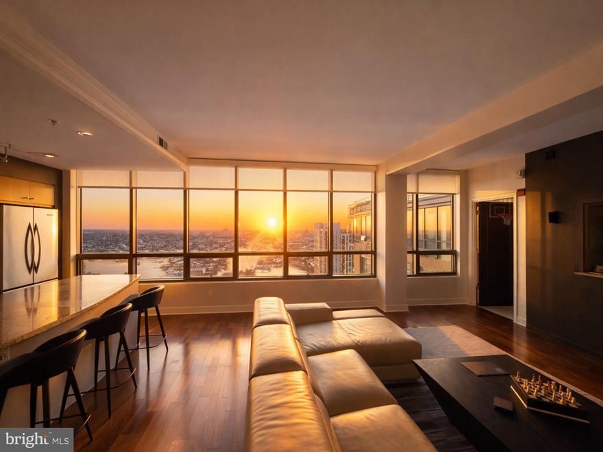 This stunning 3-bedroom, 3-bath high-rise residence offers approximately 1,900 square feet of thoughtfully designed living space, positioned 27 stories above the city. Expansive floor-to-ceiling windows fill the home with natural light while showcasing sweeping open-sky and city views.
The open-concept floor plan seamlessly connects the kitchen, living, and dining areas, creating a sophisticated yet comfortable space ideal for everyday living and entertaining. The chef’s kitchen features a large center island and is complemented by upscale finishes throughout, including rich hardwood flooring, designer lighting, custom closets, upgraded window treatments, and modern interior details.
The corner primary suite is a private retreat, highlighted by double exposures, floor-to-ceiling windows, a spacious walk-in closet, and a spa-inspired bathroom with double vanity, separate shower, and deep soaking tub. Custom electric blackout shades have been installed in the primary bedroom, with custom electric shades also added to the living area for enhanced privacy and light control. Two additional generously sized bedrooms offer flexibility for guests, office space, or additional living needs. 
Experience elevated luxury living at The Vue, located in the heart of Harbor East. Two assigned parking spaces and private storage are included, along with covered parking and 24-hour garage security for peace of mind. Residents of The Vue enjoy full-service amenities including concierge and 24-hour security, with condo fees covering heat, air conditioning, and water. The building offers direct access to the Coppermine gym, featuring indoor heated pools and squash courts, as well as the on-site Harbor East movie theater. 
Owner occupied till June.