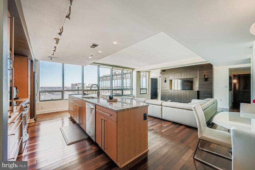 This stunning 3-bedroom, 3-bath high-rise residence offers approximately 1,900 square feet of thoughtfully designed living space, positioned 27 stories above the city. Expansive floor-to-ceiling windows fill the home with natural light while showcasing sweeping open-sky and city views.
The open-concept floor plan seamlessly connects the kitchen, living, and dining areas, creating a sophisticated yet comfortable space ideal for everyday living and entertaining. The chef’s kitchen features a large center island and is complemented by upscale finishes throughout, including rich hardwood flooring, designer lighting, custom closets, upgraded window treatments, and modern interior details.
The corner primary suite is a private retreat, highlighted by double exposures, floor-to-ceiling windows, a spacious walk-in closet, and a spa-inspired bathroom with double vanity, separate shower, and deep soaking tub. Custom electric blackout shades have been installed in the primary bedroom, with custom electric shades also added to the living area for enhanced privacy and light control. Two additional generously sized bedrooms offer flexibility for guests, office space, or additional living needs. 
Experience elevated luxury living at The Vue, located in the heart of Harbor East. Two assigned parking spaces and private storage are included, along with covered parking and 24-hour garage security for peace of mind. Residents of The Vue enjoy full-service amenities including concierge and 24-hour security, with condo fees covering heat, air conditioning, and water. The building offers direct access to the Coppermine gym, featuring indoor heated pools and squash courts, as well as the on-site Harbor East movie theater. 
Owner occupied till June.