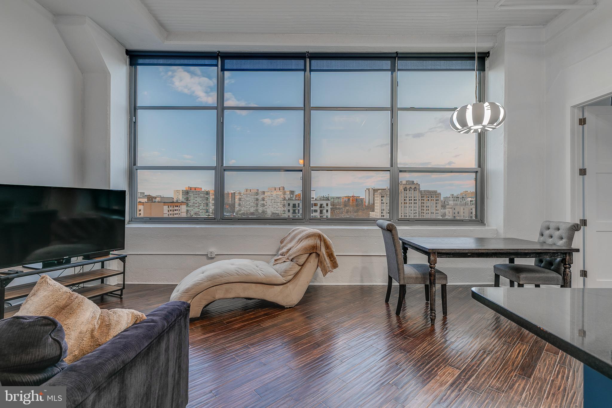 Spectacular corner industrial-style flat with 1-car garage parking in highly desirable Logan Square. This bright and airy 2 bedroom (or 1 bedroom plus office) 1.5 bathroom residence makes for the perfect pied-a-terre. Soaring 12'+ ceilings, oversized 9' windows, and breathtaking unobstructed Center City skyline and Northeast views. Thoughtful renovations and design has opened up previously unusable negative space to create a second bedroom or office. Ideal open living with hardwood floors throughout. Well appointed kitchen with custom lacquer cabinetry, granite countertops, stainless steel appliances, and pantry. French doors welcome you to the spacious primary suite with multiple exposures, the city skyline as a picturesque backdrop, and ensuite bath with frameless glass shower stall and clawfoot soaking tub. 2200 Arch is a pet friendly loft style highrise with 24 hour doorman, onsite fitness center and secure parking. Amazing location -- walking distance to Trader Joe's, Whole Foods, Suburban and 30th Street Stations, Center City business district, museums, Rittenhouse Square, The Schuylkill River Trail, and just a block away from the newly opened 65,000 square foot flagship Giant. GREENFIELD School Catchment. This unit has plenty of additional storage in both the laundry closet and lofted area above the foyer and half bathroom.