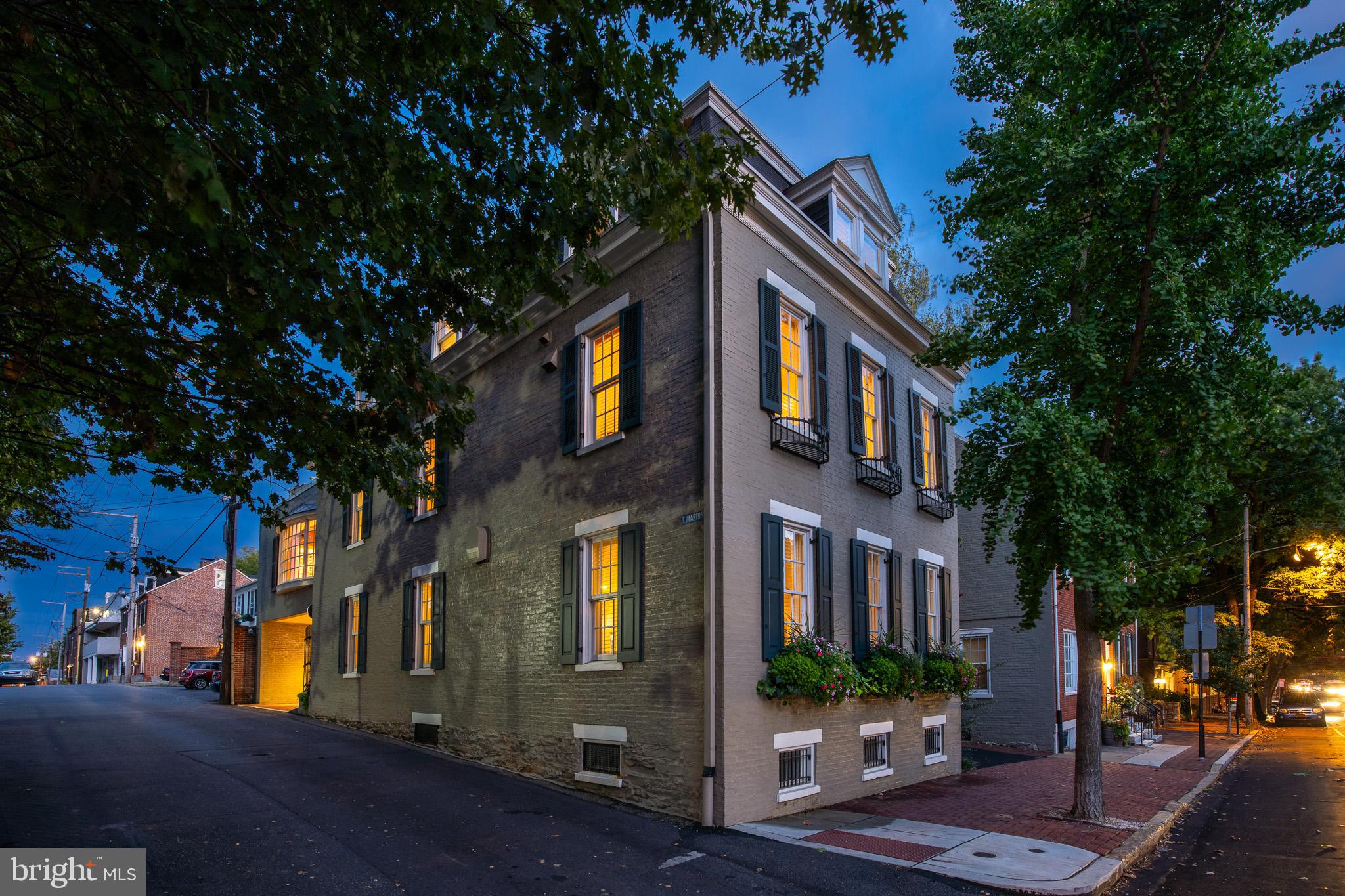 Truly a rare opportunity, this grand residence at 202 E Marion Street originally built in 1871 has been thoughtfully remodeled, a jewel of Lancaster. Live in style with no stairs as your private elevator offers easy accessibility to all floors. Luxury and sophistication exude from this immaculate historic Colonial perfectly located in the heart of downtown and popular Musser Park. It's an oasis of serenity with all the shopping, dining, arts, entertainment and everything Lancaster City has to offer just steps away. This magnificent historic home features over 3,900 square feet of living space, elevator, coffered ceilings, elegant crown moldings, built-ins, gleaming hardwood floors, and 9' ceilings throughout. Opportunities here abound as the first floor has potential for commercial space. The second floor features single floor living with an expansive custom kitchen, gas fireplace, living room, music room, family room, primary suite and beautiful views of the park. No detail has been missed, the gourmet kitchen features a complete line of high end Jenn Air appliances including gas range, double ovens, and warming drawer. It also offers a Sub Zero, Perlick beverage drawers and two wine fridges, granite counters, double sinks and a massive island with seating for 8. A wall of windows and doors open up to a balcony, overlooking your private serene brick courtyard perfect for indoor/outdoor entertaining. The primary suite has a magnificent ensuite bath featuring a gorgeous Kohler jacuzzi soaking tub, huge oversized glass walk-in shower, double vanities, laundry and heated floors. The third floor provides 2 additional bedrooms, a large full bath and an incredible sunroom with spectacular views of the park. Boasting a vaulted ceiling, gorgeous stone floors, beautiful floor to ceiling gas stone fireplace and a huge wraparound outdoor deck with plenty of space for even more outdoor entertaining and dining alfresco with dazzling views. Designed for gracious living and entertaining, this home is sure to impress. Other features include security system, remote lighting system, basement, 2 car garage + 2 off street paved parking, plantation shutters, power silhouette drapes & blinds, and more. This home is truly move-in ready and is the epitome of luxurious city living steps away from Musser Park and everything Lancaster City has to offer. Make this home yours for the Holidays and unwrap the destiny you've been dreaming of. This is a rare opportunity for such a beautiful, gracious, historic city home, call for your private tour today!