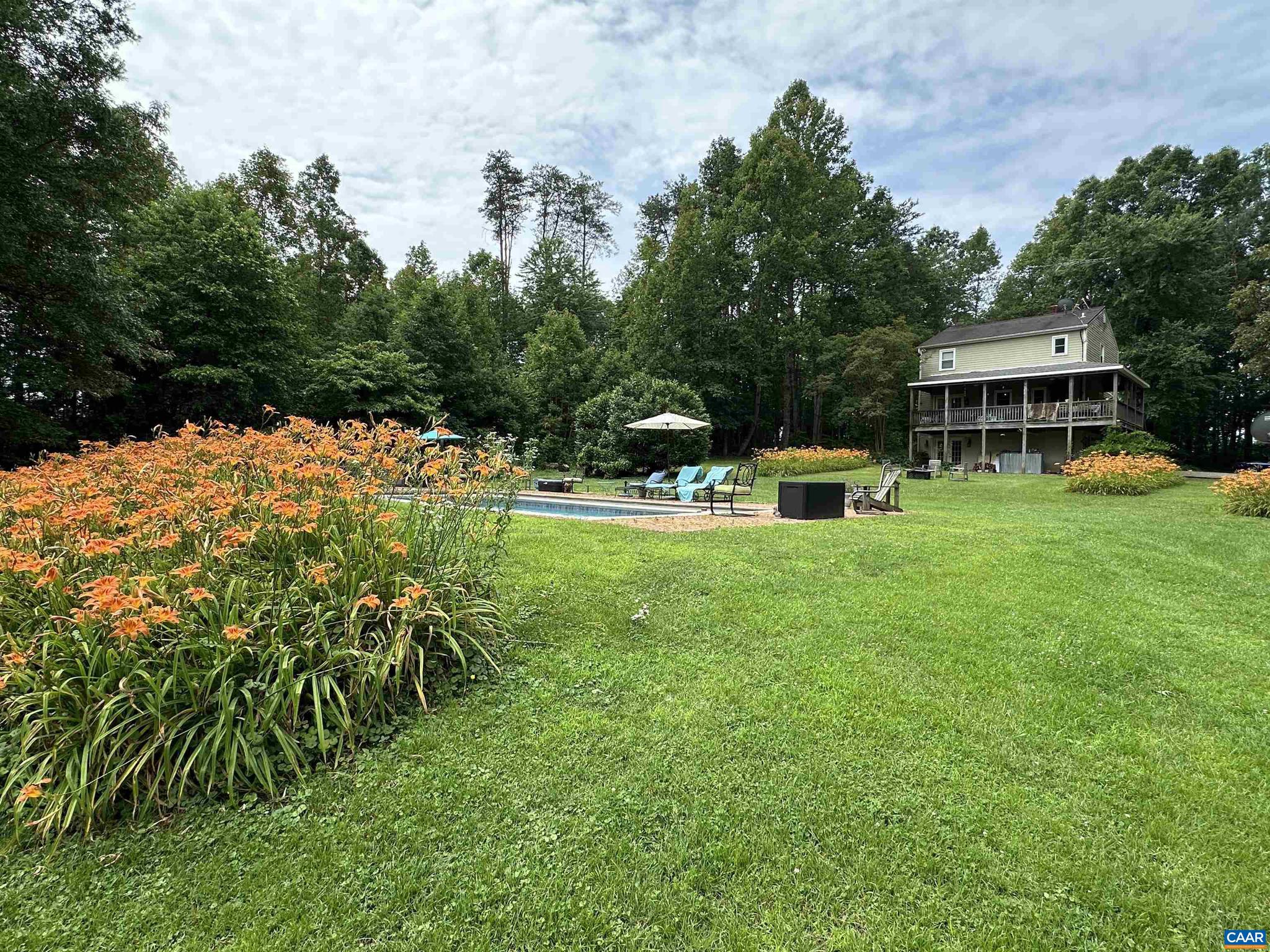 Welcome to a serene and versatile property that seamlessly blends rustic charm with modern convenience. Situated on 25.07 lush acres, this farm boasts a 2-stall barn complete with a wash stall, perfect for equestrian enthusiasts, and a chicken coop with a run. A tranquil pond adds to the picturesque landscape, offering a peaceful retreat. The property also includes a storage house with workshop space. The centerpiece is the main house, constructed in 1981. It offers 2,206 square feet with three bright bedrooms and 2.5 baths. The living room, with a gas wood stove and built-in cabinets, leads to a kitchen updated in 2016 with stainless steel appliances and a central island. The dining area opens to a large deck, perfect for enjoying views of the pond, pool, and sprawling fields. Complementing the main house is an 1800s cottage, meticulously rebuilt in 1987, providing a cozy getaway or an Airbnb option. This private oasis features a living room, kitchen, and loft bedroom with stunning views of the pond and farm. A studio terrace apartment offers views of the pond, radiant heat flooring in the bathroom, and a sleek Angola Black Granite countertop. The property is enveloped by greenery and wildlife, providing a peaceful backdrop.