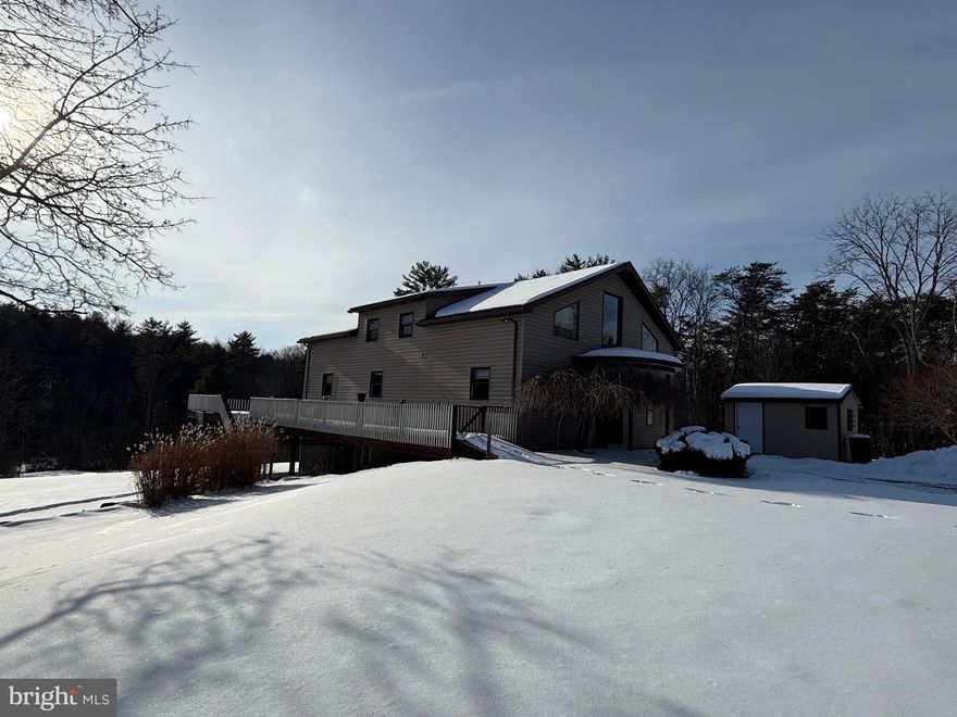 This incredible, move-in ready home has been impeccably maintained and offers a peaceful, wooded backdrop. Enjoy morning coffee on the deck while taking in the surrounding scenery. The spacious primary suite features a generous walk-in closet and an en-suite 3/4 bathroom complete with a jetted tub. Main-level bedrooms are connected by a full Jack-and-Jill bathroom, providing both convenience and functionality. Cozy evenings await in the living room, with a woodstove hookup available. The private backyard and deck are perfect for family gatherings and summer barbecues. This home is truly move-in ready—schedule your showing today.