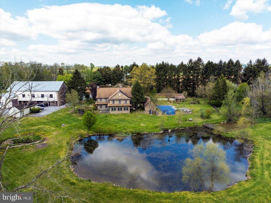 COVERED BRIDGE ESTATES Truly one of a kind! 74 Acres, (40+tillable)  Circa 1781 Farmhouse with a fabulous setting overlooking a pond with stream & preserved farm fields surrounded by hills and woodland.  Enter the main farmhouse through the foyer entrance complete with elevator for easy access to second floor. kitchen has huge, stone walk in fireplace, tile floors, corian counter top, tile backsplash, open beam ceilings,  gas stove and built in electric wall oven.  Beautiful Stone sun room addition with tile floors & walls of windows with atrium door leading to a patio & Gazebo overlooking the pond, farm fields and streams. Living room has stone fireplace and wall to wall carpeting. Family room with hardwood floors, open beam ceilings deep windowsills and brick wood burning fireplace with stairs leading to second floor. A half bath completes the first floor. Upstairs you will find 4 nice sized bedrooms including a Master Bedroom, sitting room and full bath with tiled glass enclosed shower & separate whirlpool tub, 3 additional bedrooms and 2 additional full baths. A walk up attic and unfinished full basement complete the main home. There is a detached guest cottage with kitchen & living area, 1 bedroom and full bath.  Outside you will find a newer in ground infinity pool with a summer kitchen/bath house.  Large stone bank barn with workshop and 3 large garage doors.