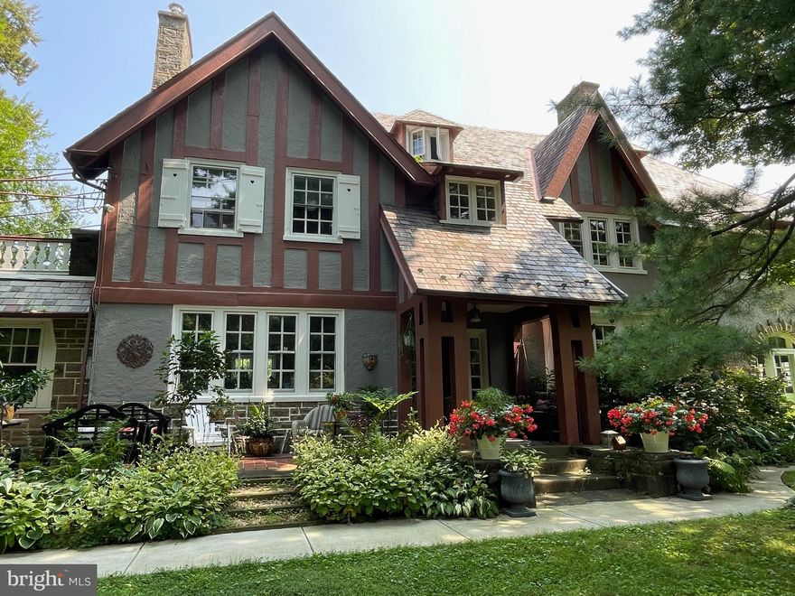 Welcome to 520 E. Sedgwick St., a distinguished home in the heart of Philadelphia’s highly sought-after Mt. Airy neighborhood. This remarkable property offers a rare blend of preserved architectural beauty, making it an exceptional find for those seeking charm and character in an urban oasis. Step through the inviting entryway and you're immediately greated by the beautifully maintained original hardwood floors, intricate moldings, and vintage design elements. The heart of the home is the large but seemingly cozy kitchen. Custom cabinetry showcasing age old craftsmanship has been thoughtfully preserved, with white upper cabinets featuring glass-paneled doors, integral lighting and peach-toned lower cabinets, adding a distinctive retro flair. The hardware and leaded glass doors maintain its vintage appeal while polished granite countertops offer both durability and style. At the center, a spacious island with a integrated oven provides ample space for meal preparation while entertaining. Modern matte black pendant lighting adds a striking contrast, while a beautiful breakfast nook bathed in natural light offers tranquil views of the lush garden.
Just off the kitchen, a classic butler’s pantry with original cabinetry and countertops provides additional storage and prep space, along with convenient back stair access to the second floor—perfect for enhancing the home’s entertaining potential. The living room exudes warmth with a grand wood-burning fireplace, rich millwork, and large windows that invite natural light to fill the space. A set of French doors open to a sunroom offering a perfect blend of historic charm and cozy elegance. Anchored by a striking floor-to-ceiling stone fireplace with a solid stone mantel, this space is ideal for both quiet evenings and large gatherings. Flanking the fireplace are built-in bookshelves adding both character and storage. Perfect for remote work, a reading space, or even a creative studio, this sunroom invites you to relax while enjoying timeless architectural details in a peaceful setting. The formal dining room, adorned with crown molding and wainscoting, creates the perfect setting for hosting dinner parties or celebrations. A versatile home office, featuring knotty pine paneling, brick flooring, and charming French doors, opens directly to the garden and patio, offering seamless indoor-outdoor living ideal for both work and relaxation. The expansive primary suite offers a private retreat, complete with a walk-in closet and exclusive access to a second-floor roof deck, perfect for enjoying a morning coffee or evening breeze.
The luxurious ensuite bathroom beautifully incorporates vintage Art Deco charm. Mint green tiles accented with black trim create a timeless design, while a four-piece layout, including a soaking tub, provides a spa-like experience. The second floor hosts three additional generously sized bedrooms, each filled with natural light, along with a beautifully appointed hall bathroom.
On the third floor, you’ll find three more bedrooms, including one with ensuite bathroom and another full hall bathroom featuring a classic clawfoot tub, further enhancing the home’s historic character. A partially finished basement offers endless possibilities for additional living space—ideal for a home gym, playroom, media room, or extra storage.
Outside, the property transforms into a private sanctuary. Three koi ponds connected by a tranquil, brook-like stream are surrounded by lush, mature landscaping. Thoughtfully designed seating areas provide both peaceful spots for quiet reflection and spacious areas perfect for hosting outdoor gatherings. Nestled on a picturesque tree-lined street, 520 E. Sedgwick St. offers the perfect balance of privacy and convenience. Enjoy easy access to local shops, charming cafes, scenic parks, and public transportation. This is truly a special property and rare a opportunity for tranquil living with all the benefits the city has to offer.