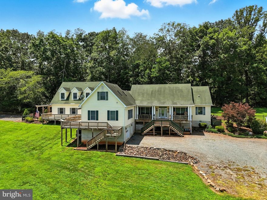 A Truly Rare and Incredible Equestrian Property!  Nestled on an expansive 11-acre lot, this property is unique in that it boasts two homes….a 4 bedroom/3 bath Rambler and 3 bedroom/2.5 bath Cape Cod, with a shared breezeway and wrap around deck!  Whether you are looking for a multi-generational property or need space to house equine trainers, guests, etc, this property is for you!
Built in 2004, the homes offer a combined 4,500 sq/ft of living space, featuring a total of 7 bedrooms and 6.5 bathrooms.  Each home offers kitchens, dining and living rooms, as well as, main level primary bedrooms.  A perfect blend of comfort and functionality that is ideal for those with equestrian-oriented endeavors, or a tranquil retreat.  The property offers two large barns – one with 6 stalls, wash stall and tack room, and the other with attached run-in sheds and tons of storage. Arena and round pen conveniently connected.  Freshly painted fencing clearly defines the multiple paddocks.  Don’t miss the attached and detached garages and tons of parking. This home is not just a residence; it's a lifestyle. Experience the perfect blend of comfort, space, and outdoor adventure in a setting that feels like a private sanctuary.  Be sure to check out the features list for more details about each home and all this property has to offer!