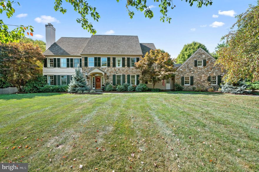 Situated at the end of a serene maple tree-lined driveway, this very special home impresses from every direction, thanks to the extensive improvements and renovations made by the current owners. Discerning buyers will appreciate the high level of craftsmanship, each space thoughtfully designed and professionally executed to create a lifestyle of functional elegance. The style of the two-story foyer is kicked up a notch with floor-to-ceiling wainscoting and a fabulous wood grain light fixture. Handsome random-width hardwood floors begin here and continue throughout the first floor for a seamless look. To the left, the spacious formal living room enjoys lots of natural light and the traditional fireplace provides an inviting space for relaxation. To the right of the foyer, the formal dining room is adorned with pretty blue and white Anthropologie wallpaper accentuated by a contemporary crystal light fixture creating a sophisticated setting for entertaining. The heart of the home is a stunningly executed family room and kitchen area. The sunken family room combines comfort and style, featuring detailed millwork with the coffered ceilings, built-in bookshelves with wood-grain countertops, recessed lighting, and a dramatic and warm stone fireplace. French doors take you to a roof-covered flagstone patio with skylights, ceiling fan, built-in outdoor heater, outdoor speakers, and a stone knee wall offering lots of seating for parties. All of this overlooks the enclosed pool, play area, and gardens. The pool has undergone a gorgeous renovations, is accentuated by professional landscaping, and is enclosed with estate fencing. Beyond the pool are spacious flat grounds, gardens, play spaces, and a tucked-away treehouse providing a magical place for young imaginations to run wild. Back inside, the fabulous gourmet kitchen features white shaker cabinets, Calacatta quartzite counters, and tile backsplash. Enjoy the 5-burner Bosch range, a Bosch dishwasher, Bosch double ovens, and a seamless built-in Thermador refrigerator. The expanded island serves as a striking centerpiece while the spacious breakfast room offers access to a beautiful flagstone patio. The butler’s pantry with a Sub-Zero wine bar, fridge, and glass cabinetry adds to the space’s entertaining-friendly design. To the left of the family room is a private office with glass French doors, a cozy fireplace, built-in bookshelves and workspace, and patio access. Function and style marry perfectly in the double-mudroom space with both flagstone and herringbone tile floors, custom built-in lockers, a well-appointed laundry station with custom cabinetry, folding table, and space to hang clothes. The three-car garage features an epoxy floor, organization system, ample storage, high ceilings, and an exterior door for convenience. An everyday powder room in the mudroom and a formal guest powder room between the living room and office complete the first floor. The second level offers 5 bedrooms and 4 full baths. The luxurious primary suite boasts tray ceilings, hardwood floors, dual closets, and a spa-like bathroom with exceptional finishes. A second floor addition created a stunning bedroom suite with exposed stone, vaulted beam ceilings, a fabulous full bath with spacious glass-enclosed style shower, and a custom walk-in closet tucked behind a pocket door. Completing the second level are three spacious bedrooms including one with a private bath. On the lower level of the home is a beautifully renovated finished basement with a large TV room space including built-in shelving, a separate play area, a guest room or workout space, and another stylish full bathroom. The lower level has outdoor access and a storage/utility room. This home blends timeless elegance with modern luxury and offers a one-of-a-kind living experience for the discerning buyer. Schedule your private showing today to experience the unmatched beauty and quality of this exceptional property.