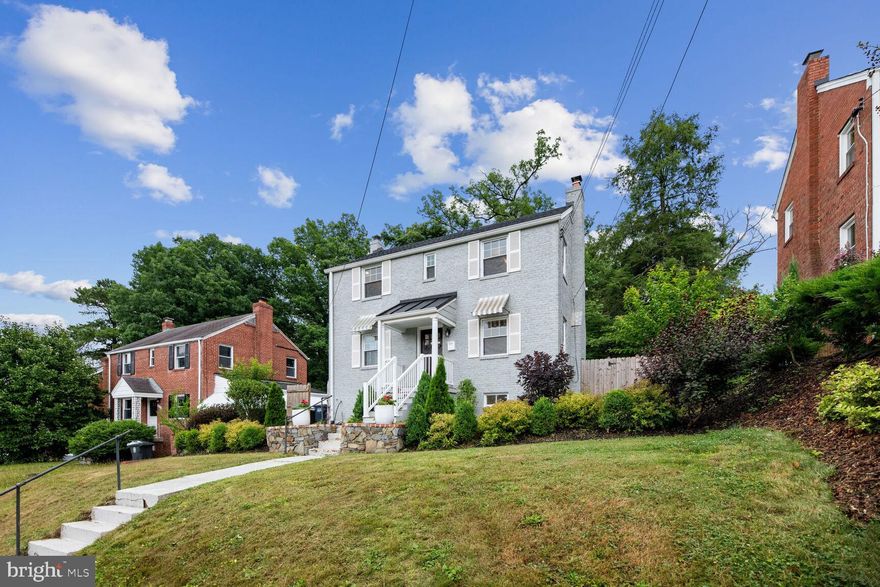 1 Block from DC ! Beautiful all brick colonial Fresh renovation from top to bottom. Bluestone walkways carry you up to a column front porch covered with black metal roofing. A mahogany stained door welcomes you into the main level of this home. The main level features open dining and kitchen. Custom cabinetry and high quality quartz counter tops. Main level also features a living room with crown molding and a wood burning fireplace wall. A light filled sunroom is accessed off of the living room. The sunroom features a full bath with stand up shower. The sunroom provides access to a paver patio, perfect for entertaining. There is also a beautiful large yard for gardening, entertaining, pets, etc. New hardwood flooring, and LVP in the lower level. The upper level is 3 bedrooms with full bath with medicine cabinet and storage niche. The lower level bedroom is technically a den but has a beautiful and generous full bath with luxurious shower. The lower level has a private entrance from rear and high ceilings,  family room and laundry. . This home has double hung low E windows, architectural 25 yr shingle roof, and new forced air HVAC. This house is a must see!