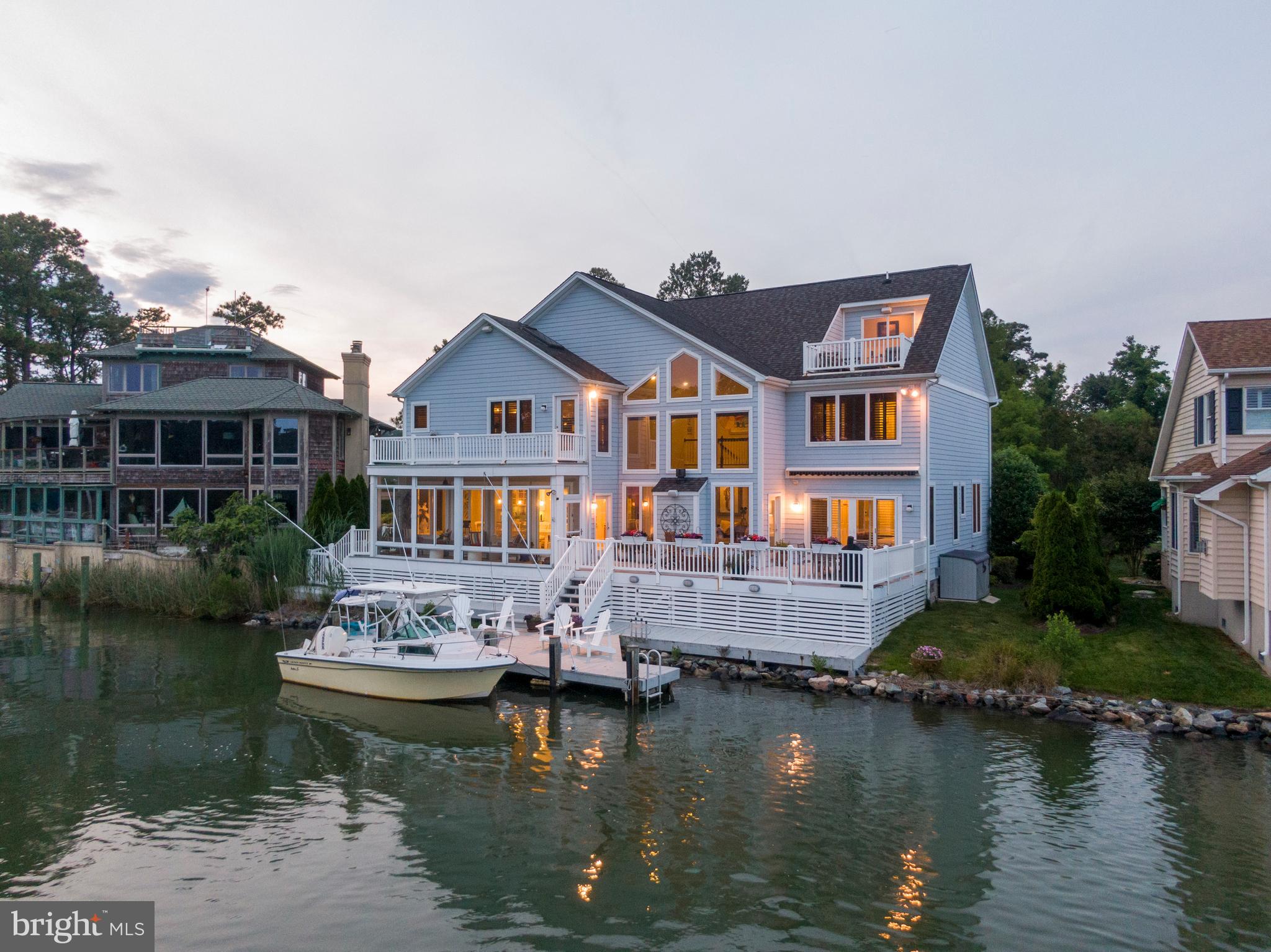 Live the ultimate coastal lifestyle in this 5BR, 4.5BA custom bayfront retreat in coveted West Ocean City. With unobstructed open water views, a private dock and over 4,300 sq ft of beautifully designed space, this home is packed with smart upgrades and luxury finishes.
Features include a vaulted great room with powered blinds, multi-zone heated tile floors, chef’s kitchen, and main-level primary suite. Enjoy high-tech touches like WiFi-enabled thermostats, dock lighting, and ventilation, plus a Tesla charger, Blink cameras, and invisible in-wall speakers.
Relax under the remote-controlled awning, take in the ocean view from your crow’s nest balcony, or retreat to the “secret” bonus room. Extensive storage, whole-yard irrigation, uplighting, and pre-wired generator backup complete this dream home. NO HOA!!