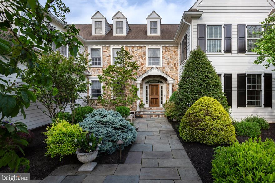 This elegant colonial home in Willistown Township combines timeless design with modern amenities, meticulously updated over the past decade. Built by T.A.G. Builders, the property features a complete stucco remediation replaced with Hardie Board siding, upgraded windows, a new front door, and a host of high-quality finishes. The exterior boasts a luxurious pool with an integrated hot tub and slate surround, a pebble paver terrace, and a well-maintained private fenced yard with custom lighting. Inside, the main level includes generously-sized rooms with custom millwork, back stairs, and beautiful hand-painted hardwood flooring. Highlights include a formal fireside living room, a separate dining room, a chef-worthy kitchen with a butler’s pantry, a light-filled breakfast room, a stunning office, a large fireside family room, and a spectacular brick-floored mudroom featuring a built-in dog bed and multiple cubbies. The second floor offers five bedrooms and three bathrooms, including a spacious main suite, a guest suite with a sleeping alcove, and two bedrooms connected by a full bath. A large sunny laundry room with built-ins and a stairway leading to a floored attic space complete this level. The extensively finished lower level is equipped with engineered hardwood flooring and window egress. It features a great room with a kitchen area, a family/sitting room with a gas fireplace, an exercise room with rubberized flooring, a full bath with marble tile, and a storage room. Large barn doors elegantly separate these spaces. Situated on a cul-de-sac street in the heart of Willistown Township, known for its cultural and historical significance and proximity to Radnor Hunt, this home is part of the award-winning Great Valley School District and close to several private schools. Conveniently located near regional rail and Amtrak services, and just a short drive from the shops and restaurants of Malvern, Paoli, West Chester, Wayne, and King of Prussia.