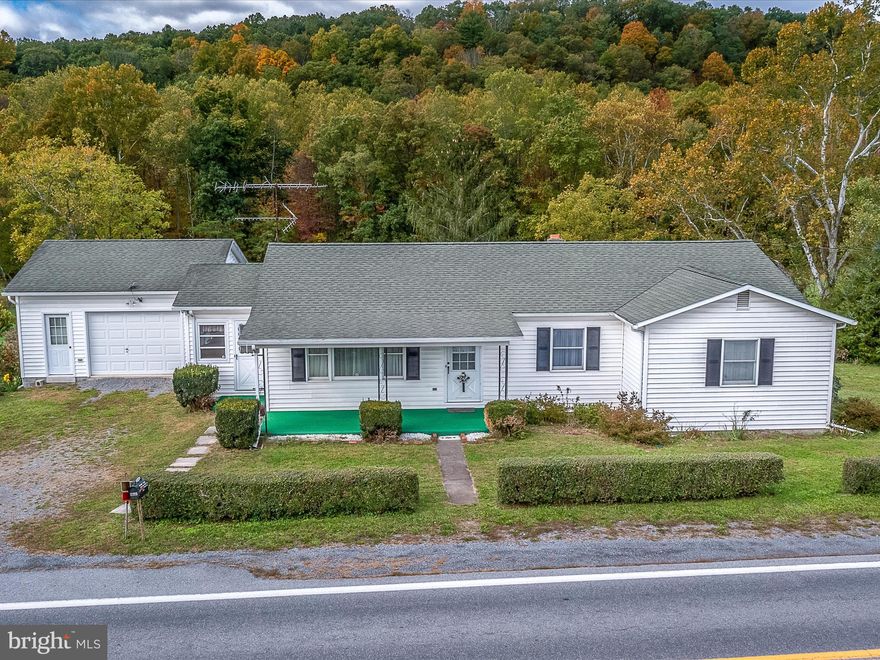 Drive out to the country and enjoy easy one level living on 4.02 acres along a state maintained road. This great starter home needs a new owner to love it back to it's grandeur! Bring the animals-you can have your chickens, horses, goats or whatever your favorite furry creature with room to roam!  3 bedrooms, 2 baths on a full partially finished basement with additional basement garage for lawn care equipment.  Primary bedroom with double closets and attached full bath. Traditional style floor plan with connecting garage and enclosed side porch on the main level.  UNRESTRICTED-this could be great for a home business or short term rental use.  SOLD AS-IS AND SELLER WILL MAKE NO REPAIRS.